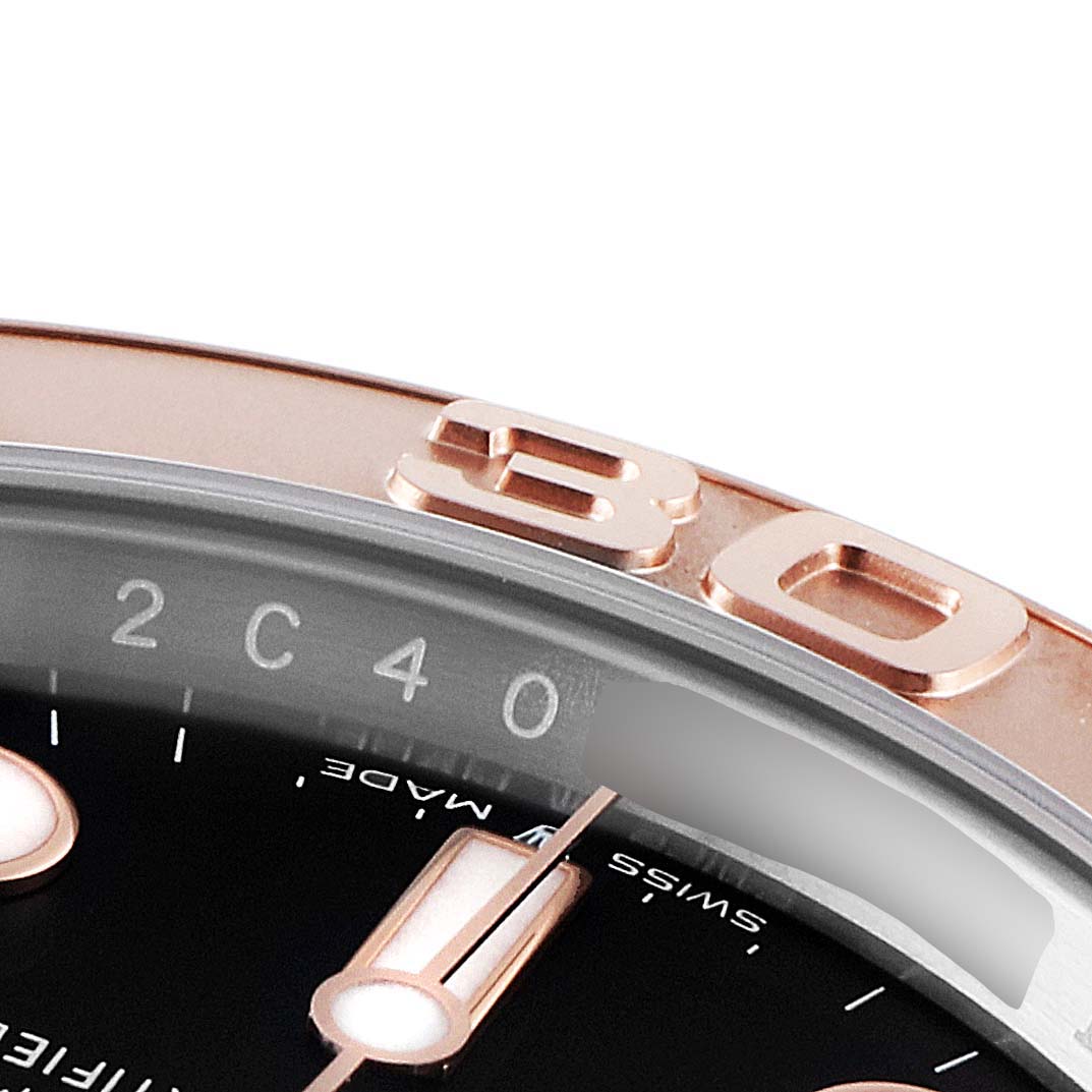 The image shows a close-up view of the bezel and part of the dial of a Rolex Yacht-Master 126621 Men's Rose Gold Black Dial 126621 Men's Rose Gold Black Dial watch.