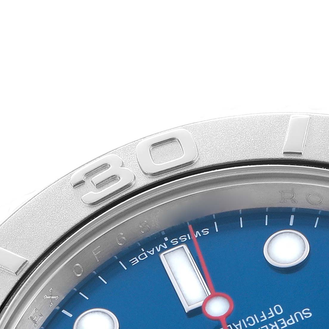 The image shows a close-up of the Yacht-Master by Rolex, highlighting the bezel and part of the blue dial.