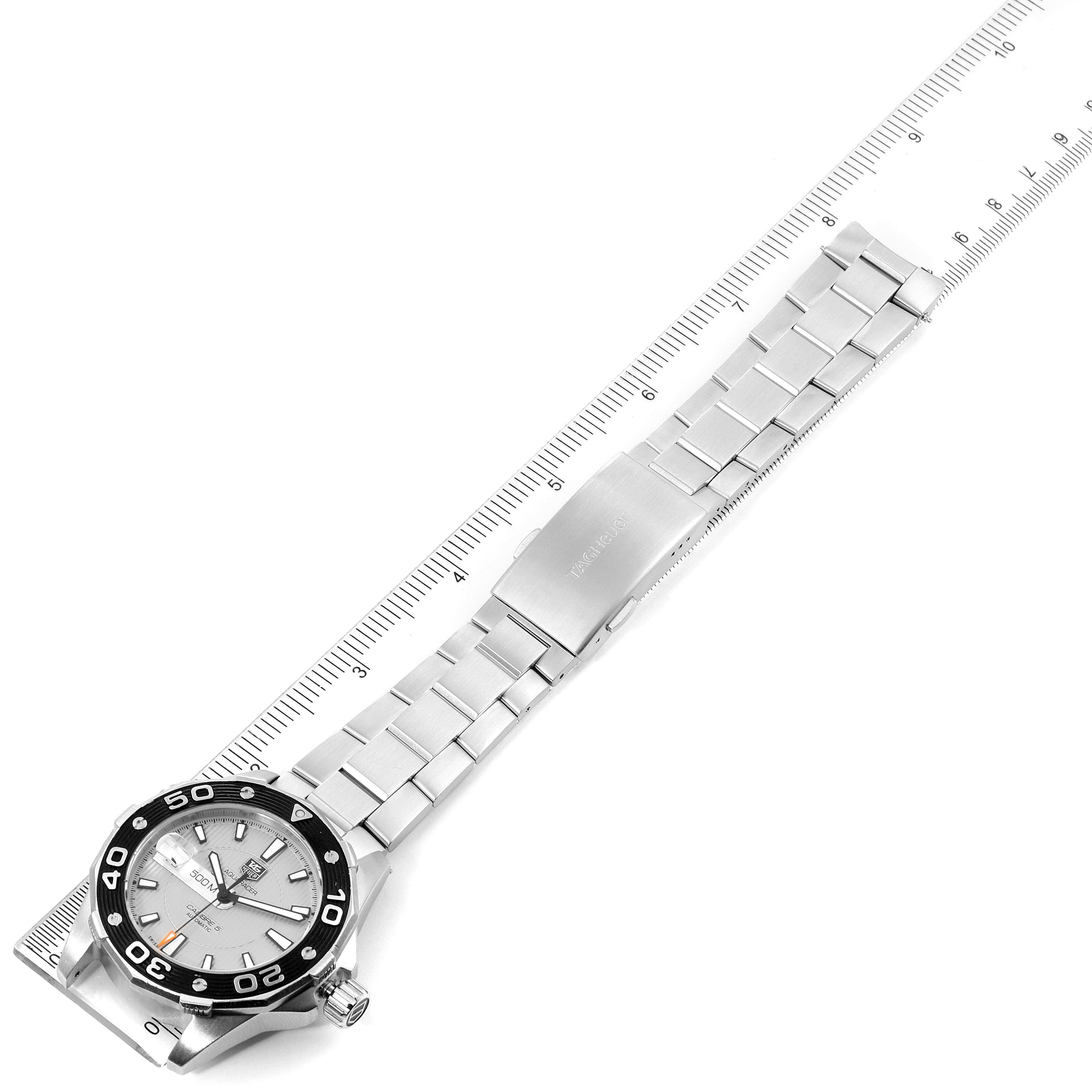 This image shows a Tag Heuer Aquaracer WAJ2111.BA0870 Men
s Stainless Steel Grey Dial WAJ2111.BA0870 Men
s Stainless Steel Grey Dial watch from an angled top-down perspective with a ruler for scale.