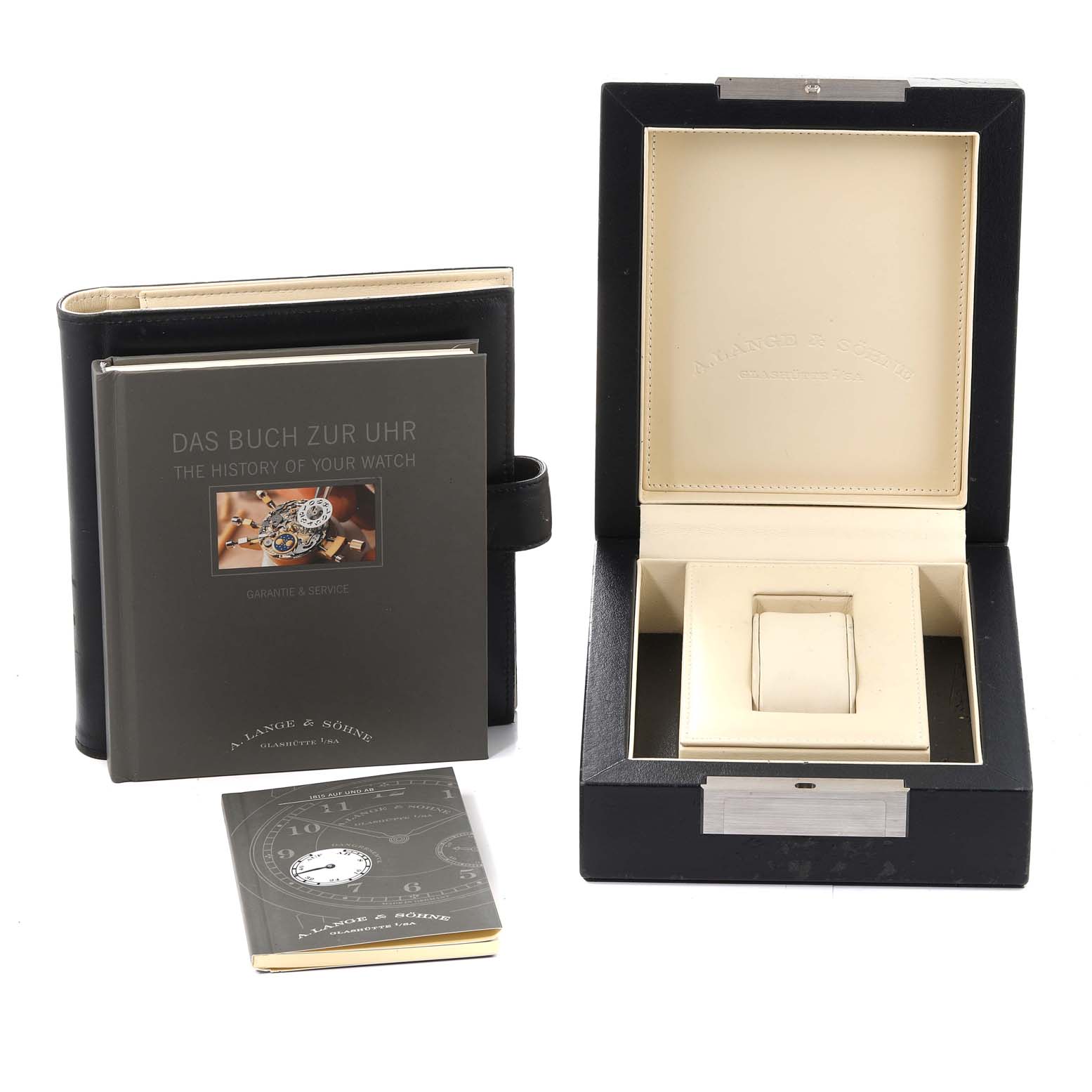 The image shows the packaging, instruction manual, and warranty booklet for the 1815 model watch by A. Lange & Söhne.
