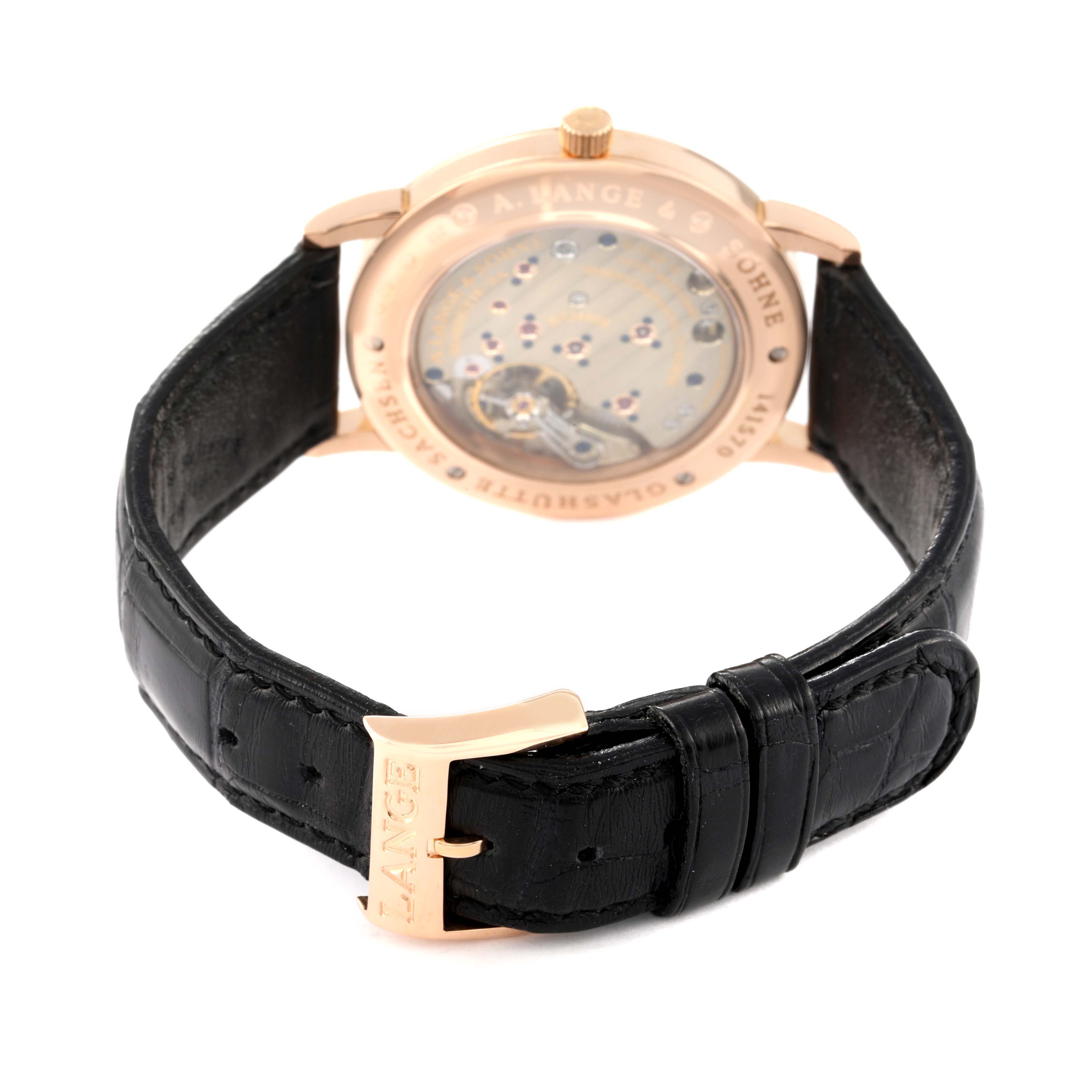 The image shows the back view of the A. Lange & Sohne 1815 221.032 Men's Rose Gold Silver Dial watch, focusing on the movement and black leather strap with a buckle.