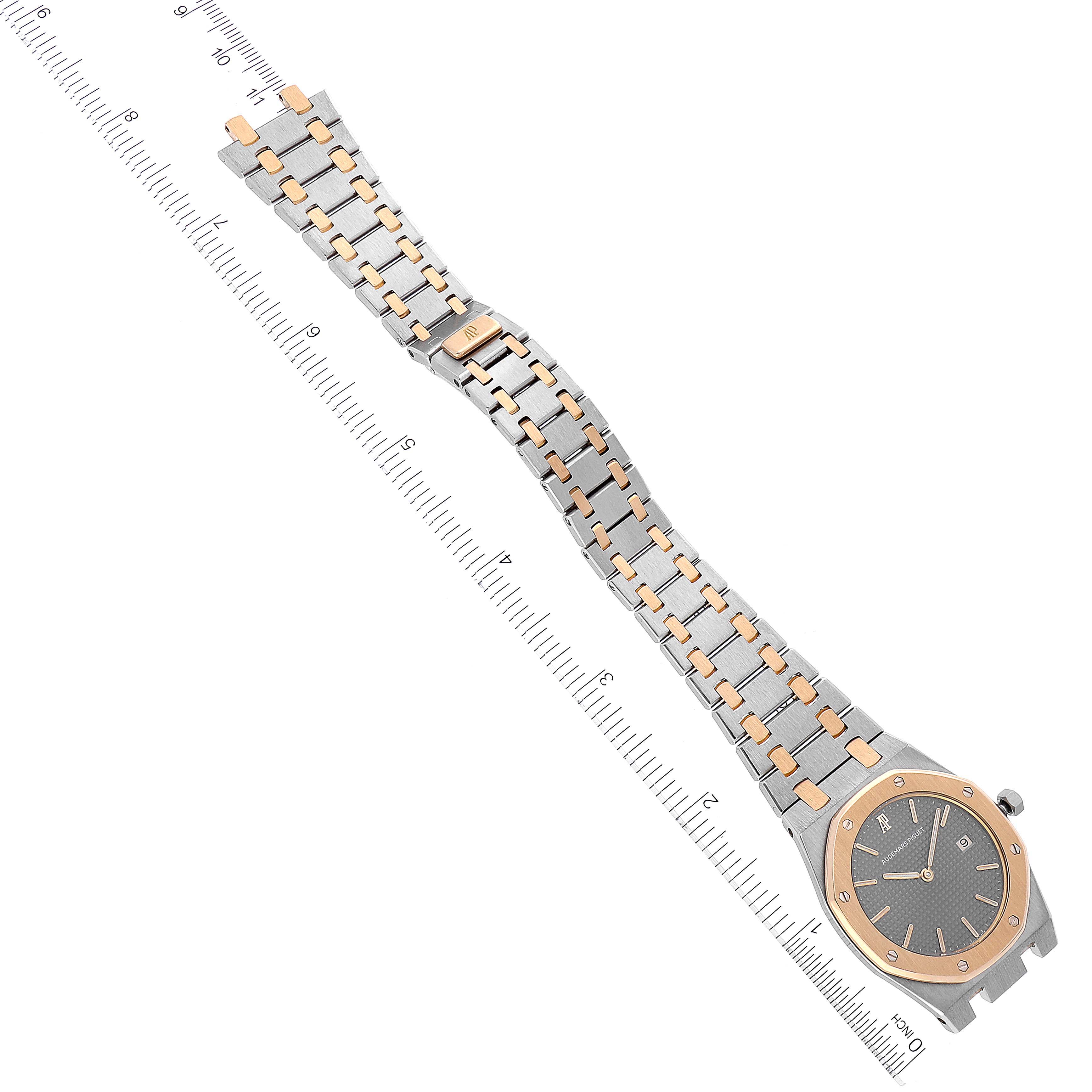 This image shows the Audemars Piguet Royal Oak 56175SA.OO.0789SA.01 Men's Steel and Gold (two tone) Grey Dial 56175SA.OO.0789SA.01 Men's Steel and Gold (two tone) Grey Dial watch from a top-down angle, highlighting the face and bracelet with a ruler for scale.
