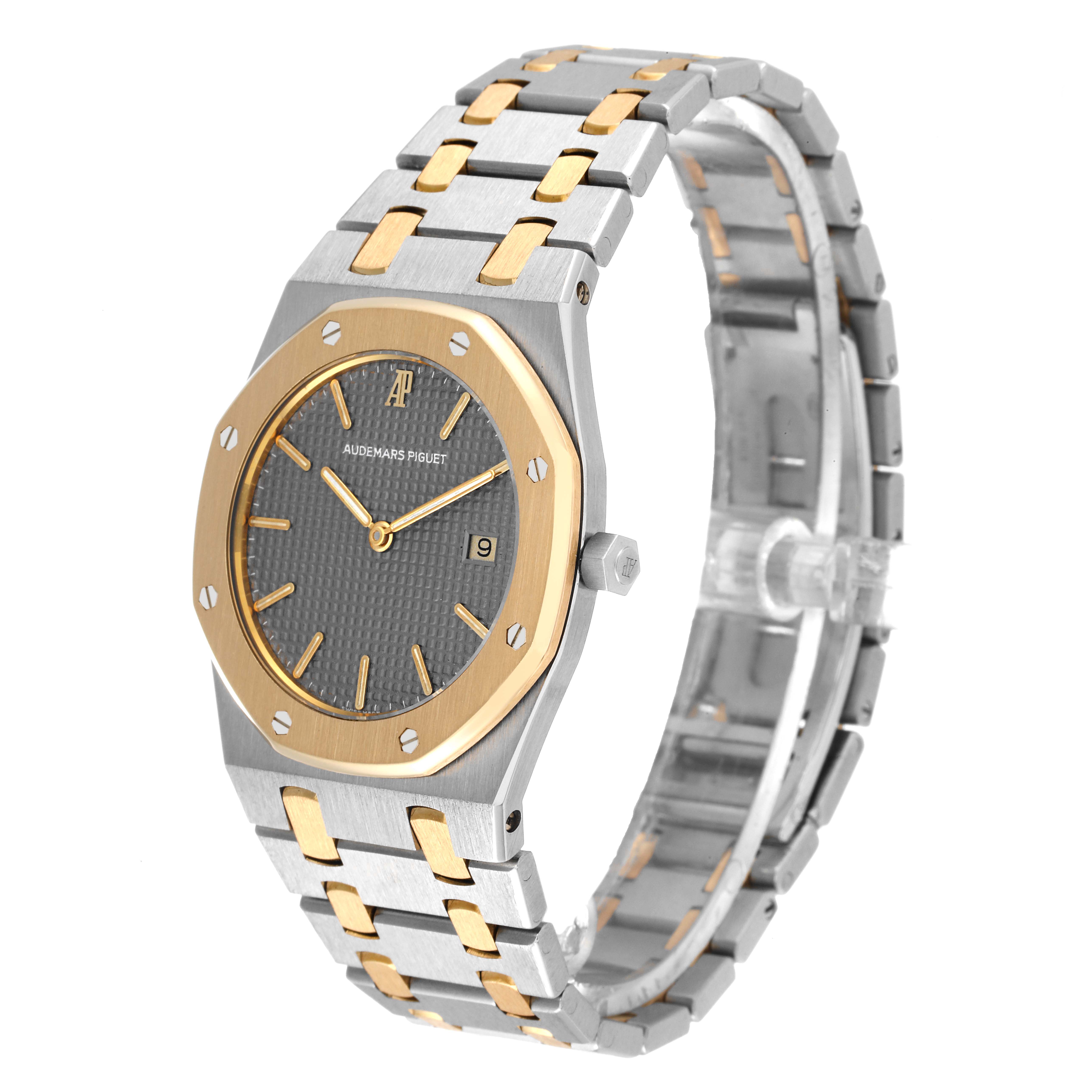 The image shows a Royal Oak model by Audemars Piguet at an angled side view, highlighting its two-tone bracelet, case, and dial.