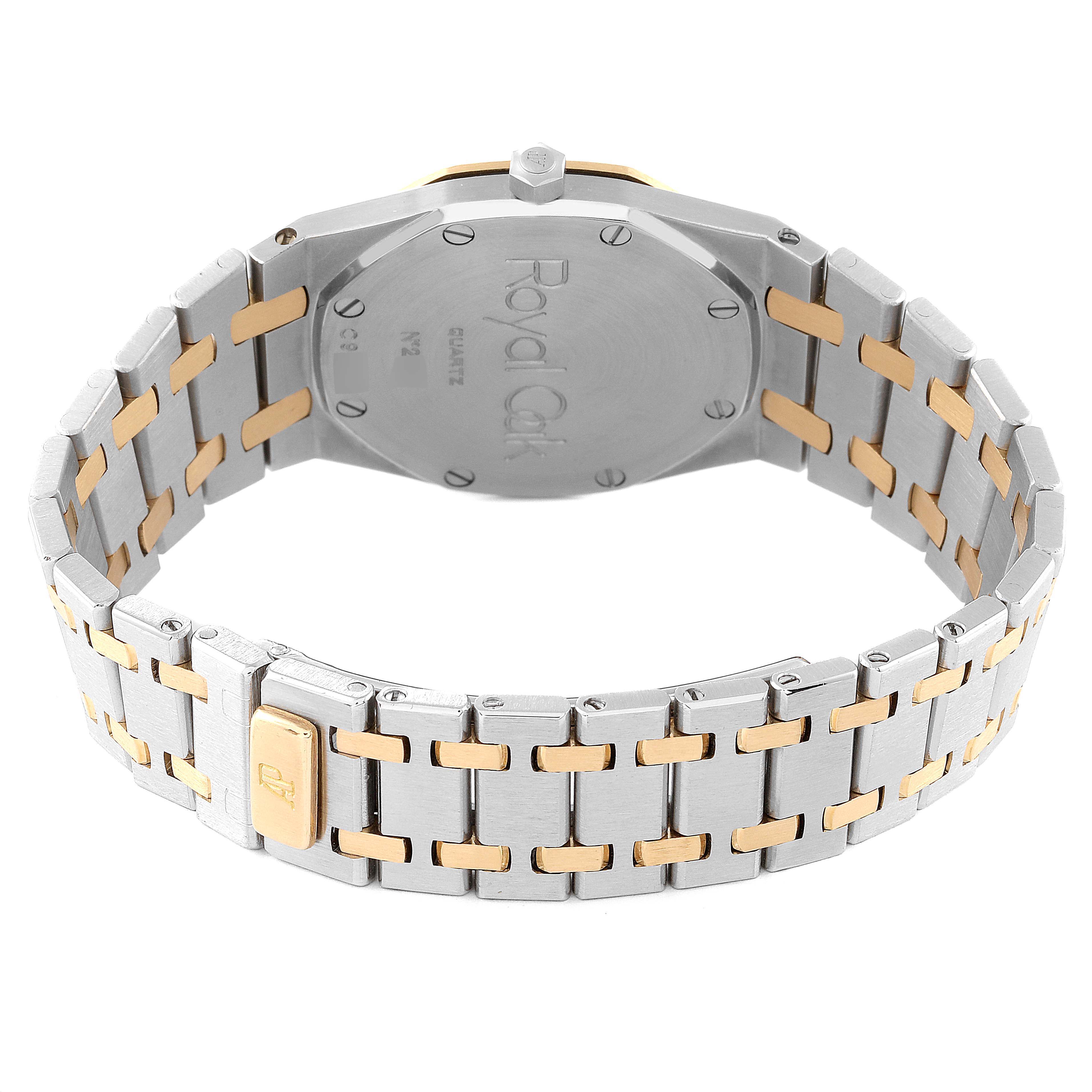 The image shows the back view of a Royal Oak watch by Audemars Piguet, highlighting the case back and the two-tone metal bracelet.