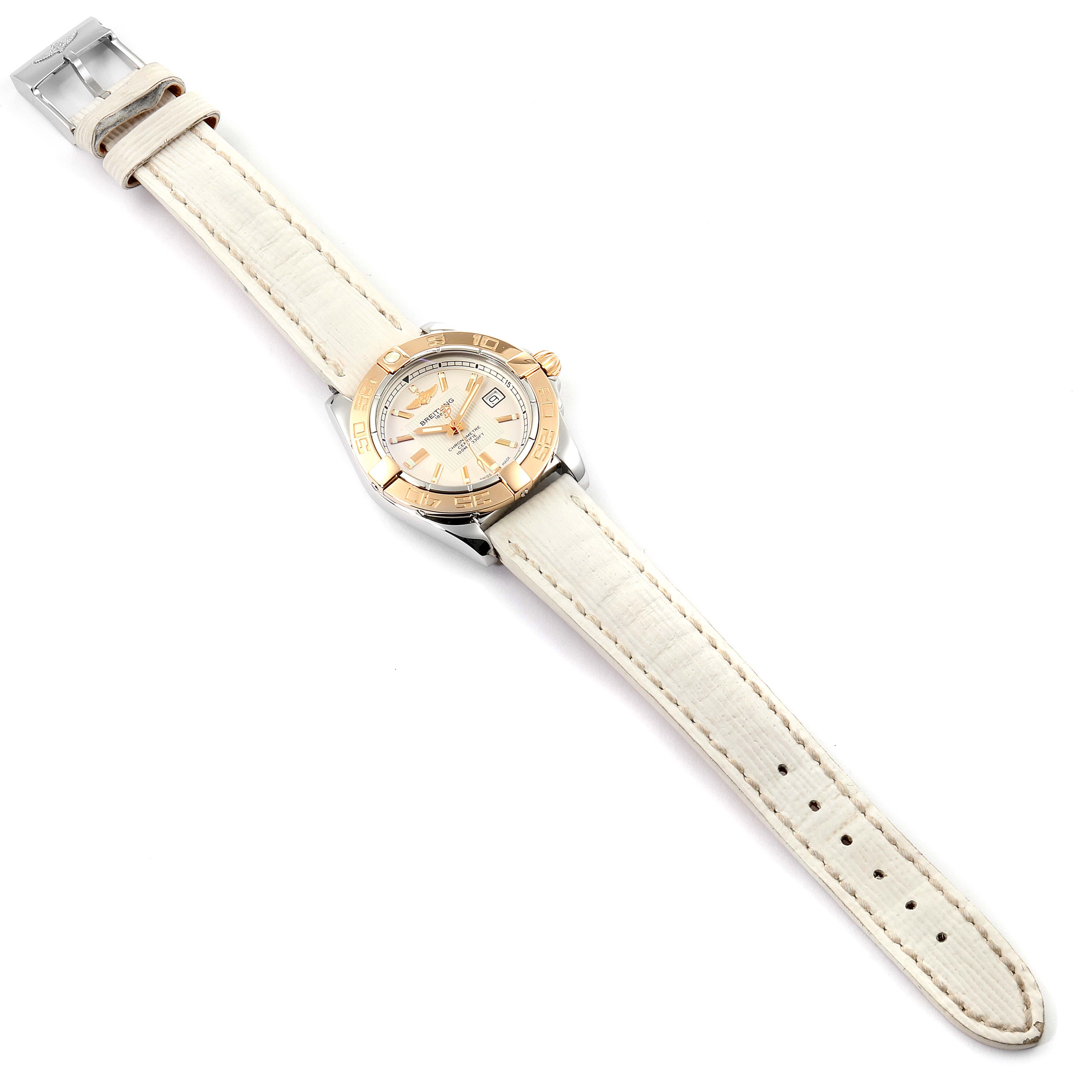 The image shows the Breitling C71356 Women's Steel and Gold (two tone) Silver Dial C71356 Women's Steel and Gold (two tone) Silver Dial Galactic 32 Steel Rose Gold White Strap Ladies Watch C71356 from a top-down angle, displaying the full strap and watch face.