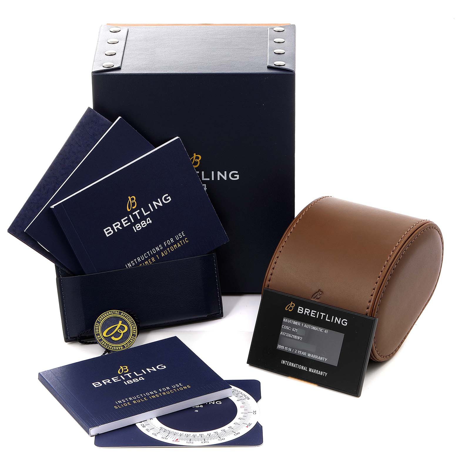 The image shows packaging and accessories for the Breitling Navitimer A17326 Men's Stainless Steel Black Dial A17326 Men's Stainless Steel Black Dial, including manuals, a leather case, a box, and warranty information.