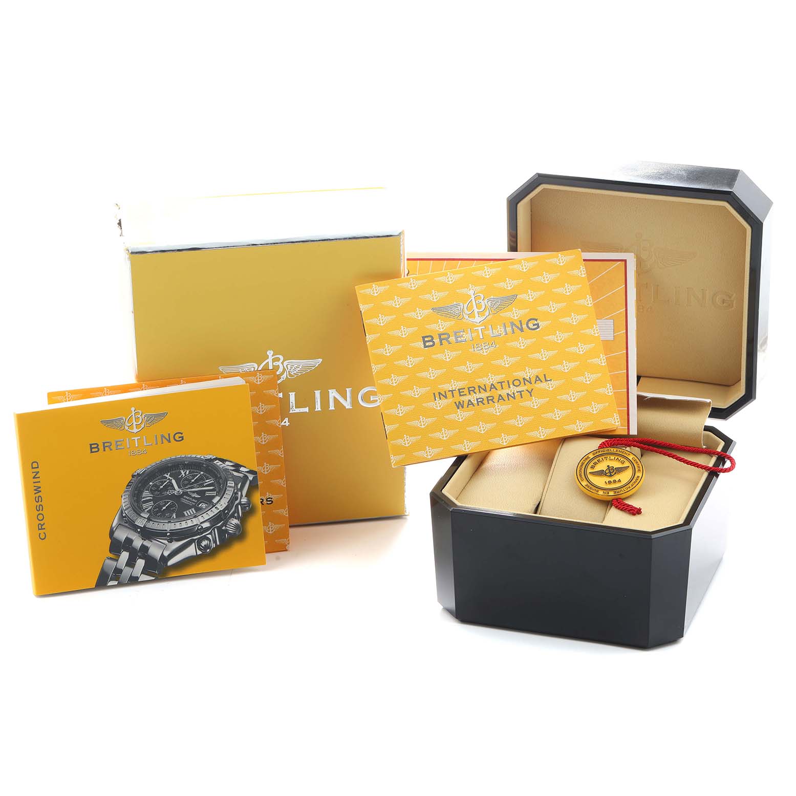 The Breitling Windrider B13355 Men's Steel and Gold (two tone) Blue Dial watch accessories include a box, manuals, and warranty cards displayed from a slightly elevated angle.