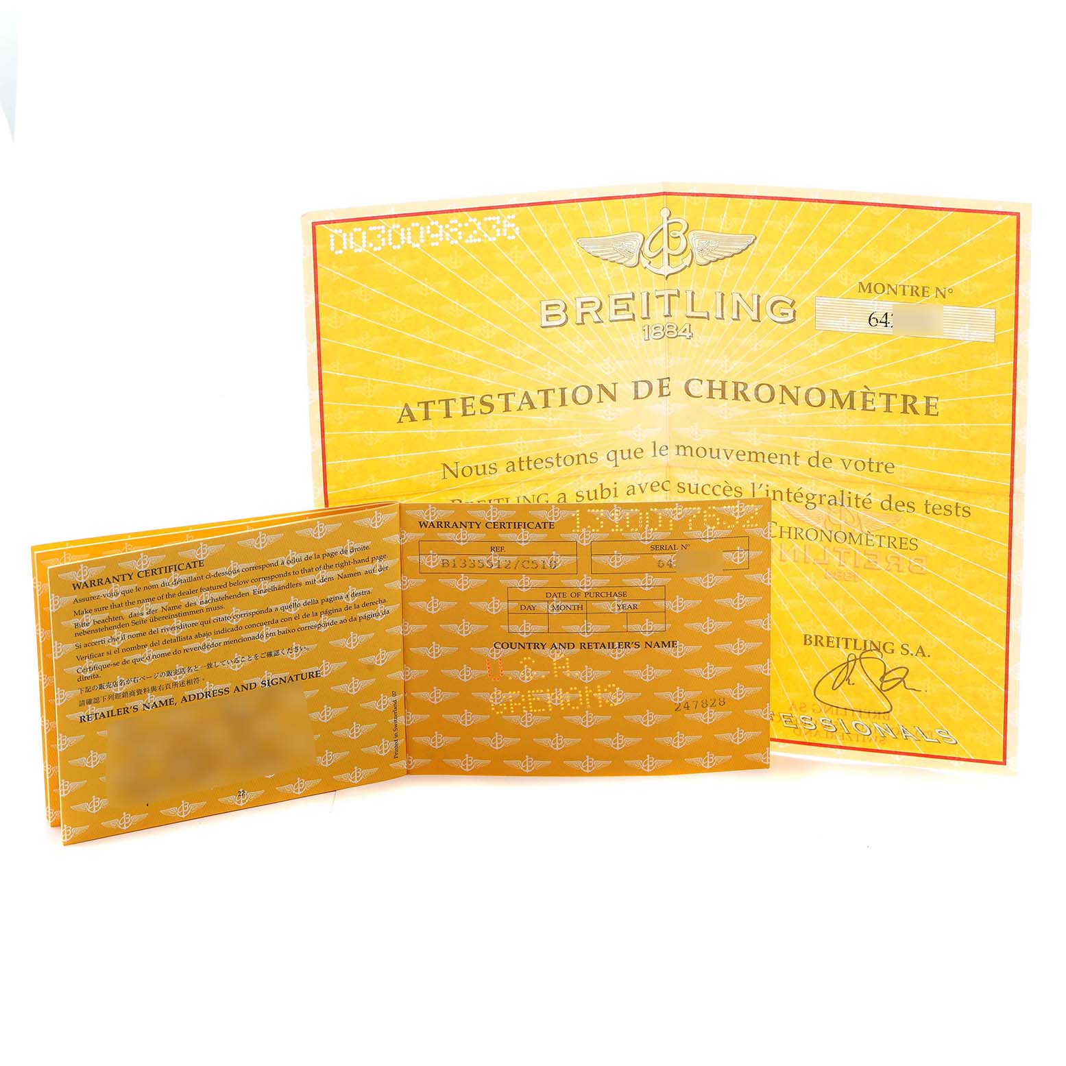 The image shows warranty and chronometer certificates for a Breitling Windrider B13355 Men's Steel and Gold (two tone) Blue Dial, both positioned flat and open.