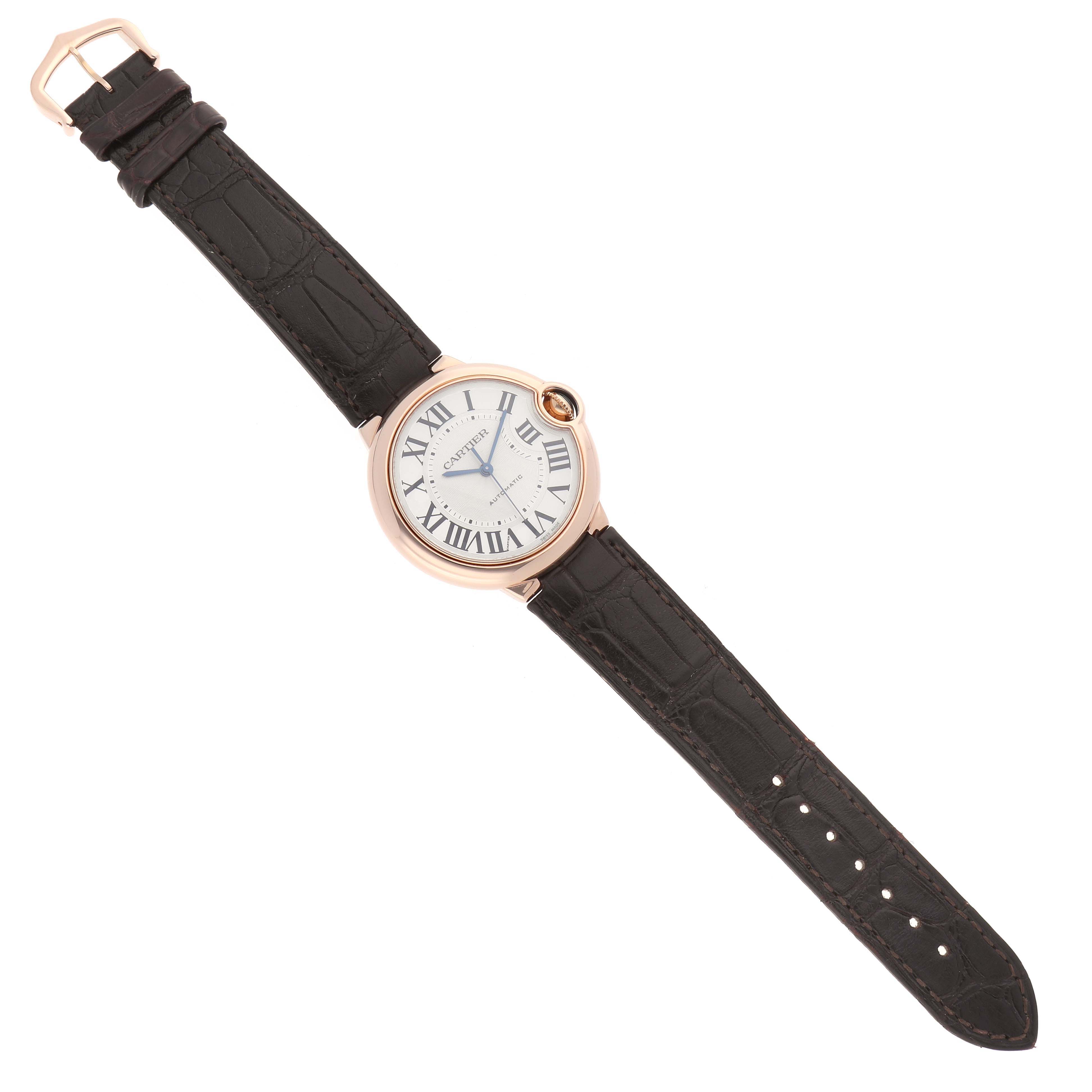 The Cartier Ballon Bleu WGBB0009 Women's Rose Gold Silver Dial watch is shown from a top-down angle, highlighting the round face, Roman numerals, and leather strap.