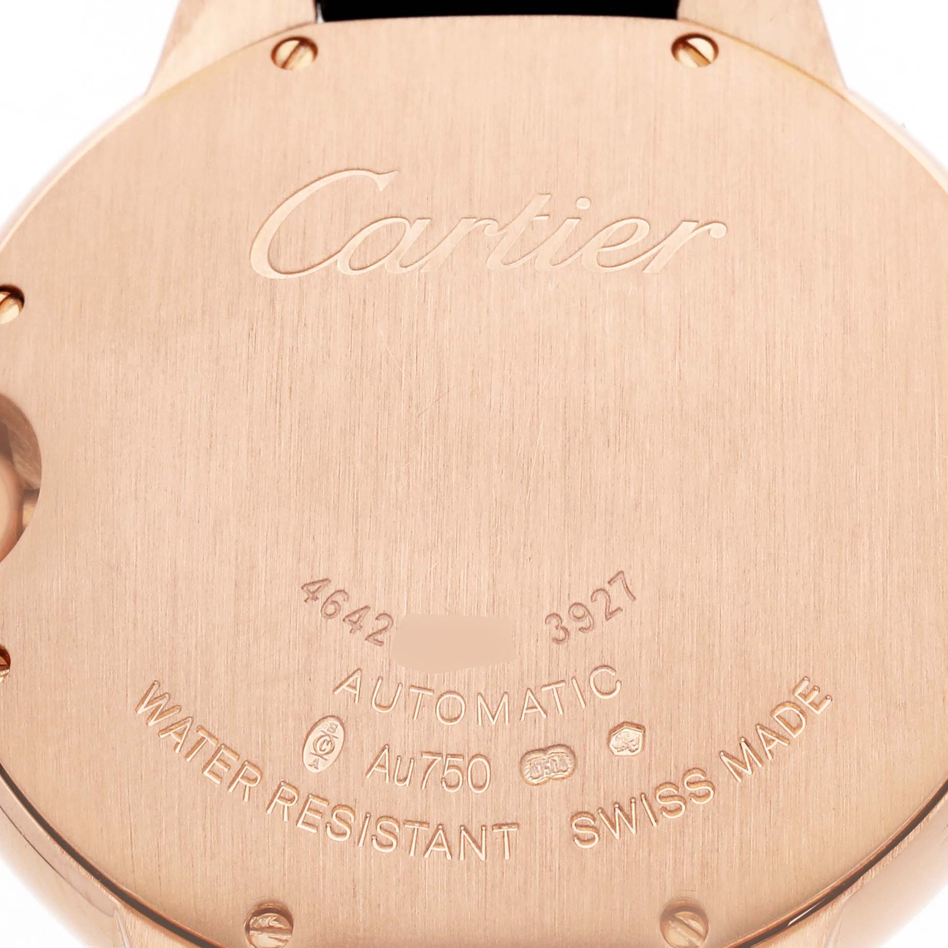 The image shows the back of a Cartier Ballon Bleu WGBB0009 Women's Rose Gold Silver Dial watch, displaying engravings for water resistance and material details.