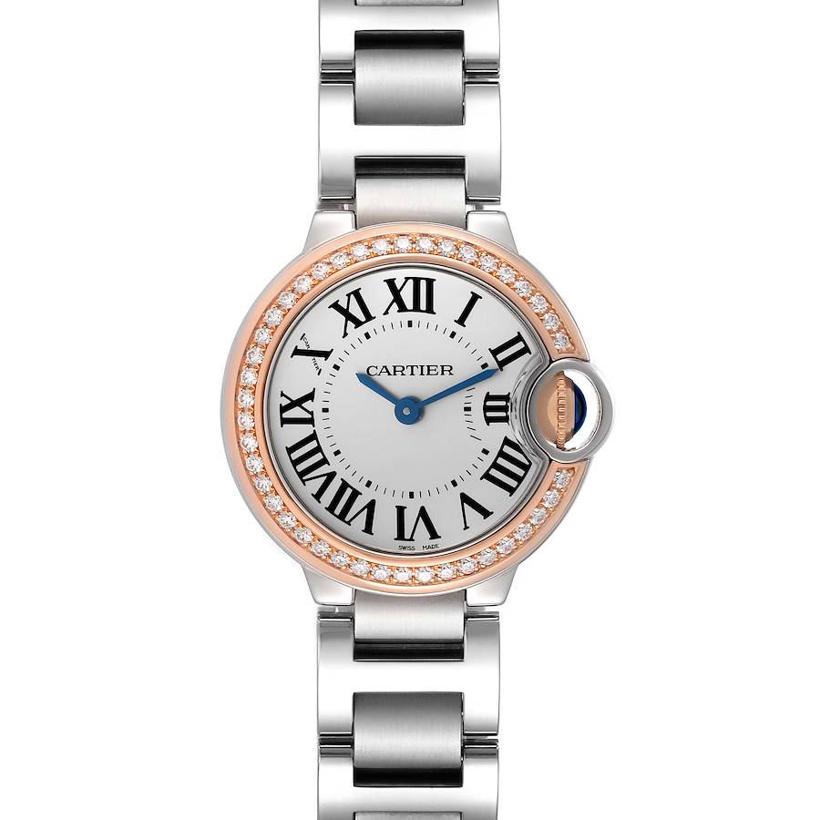 The Cartier Ballon Bleu watch is shown from a top-down angle, displaying its face, bezel, and stainless steel bracelet.