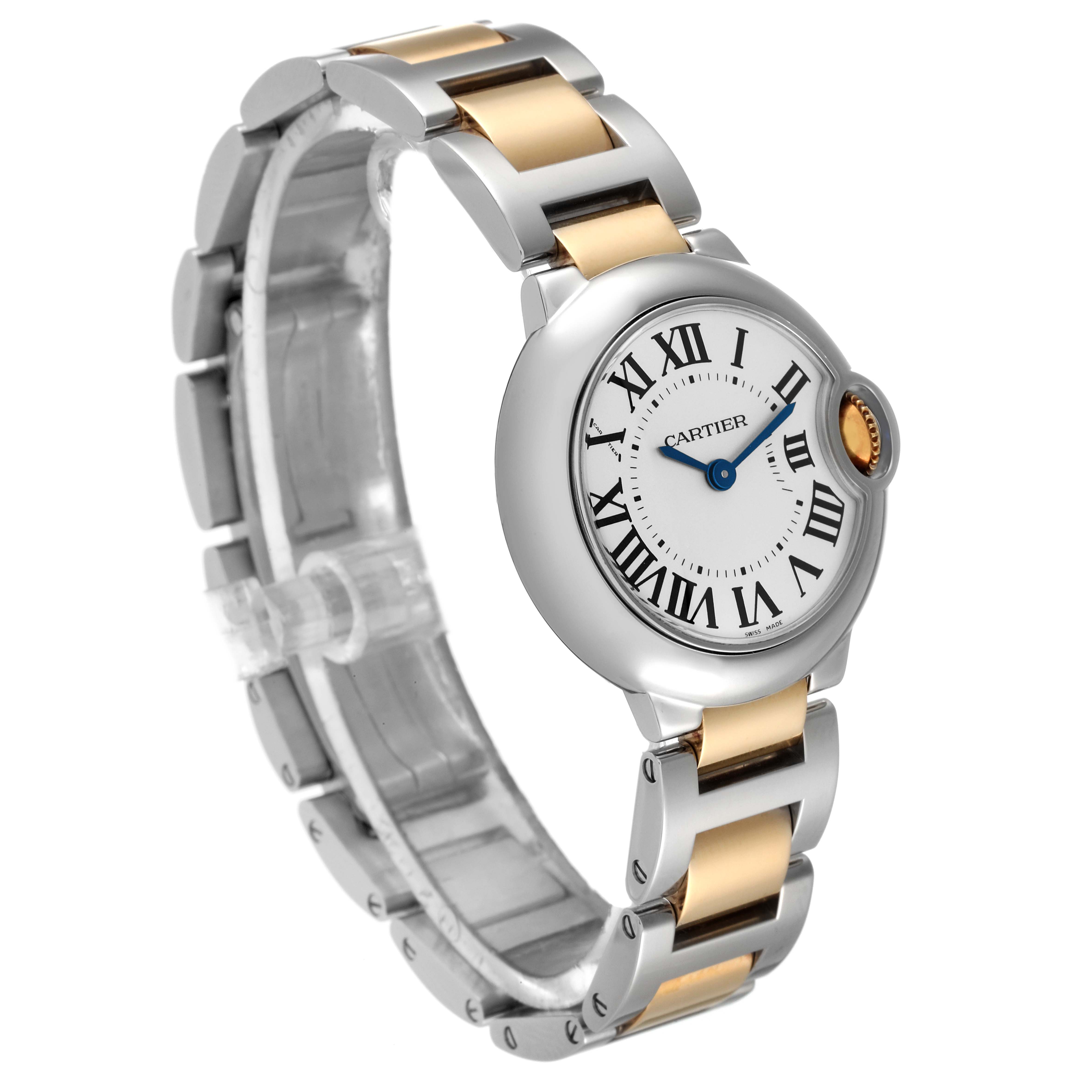 The Ballon Bleu de Cartier watch is shown at a slight angle, highlighting its round face, Roman numeral dial, and two-tone metal bracelet.