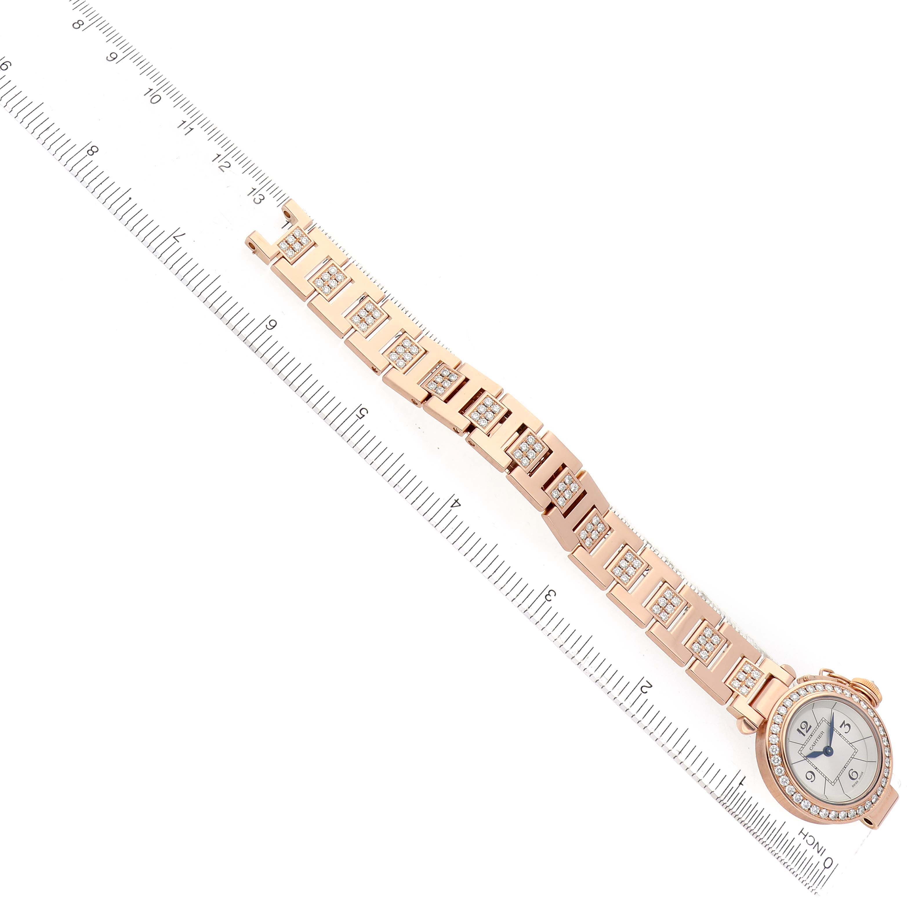 The Cartier Pasha WJ124019 Women's Rose Gold Silver Dial model watch is shown from a top-down angle, displaying the entire band and face alongside a ruler.