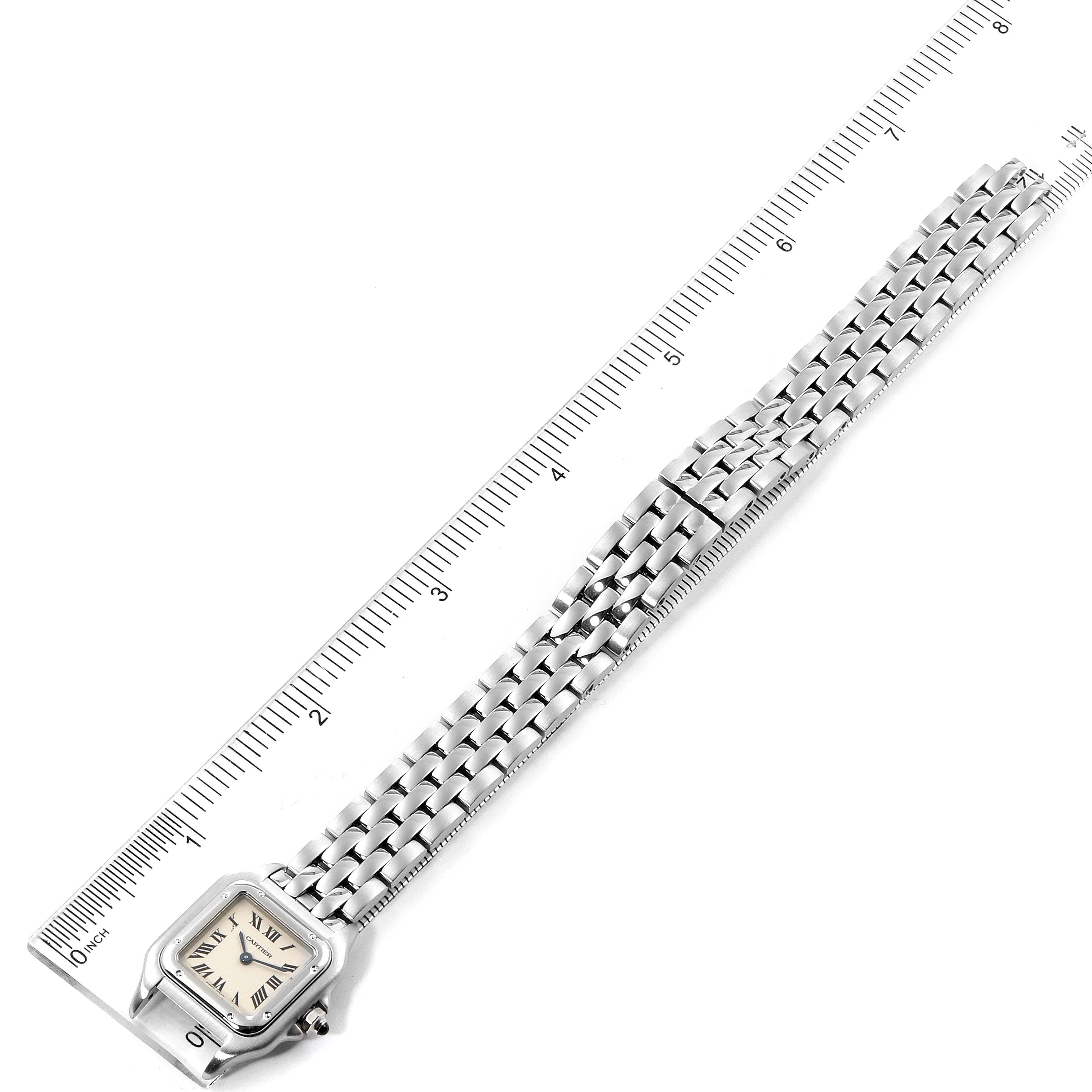 The image shows a top-down view of a Cartier Panthere W25033P5 Women
s Stainless Steel Silver Dial W25033P5 Women
s Stainless Steel Silver Dial watch with its face and metal bracelet laid next to a ruler.