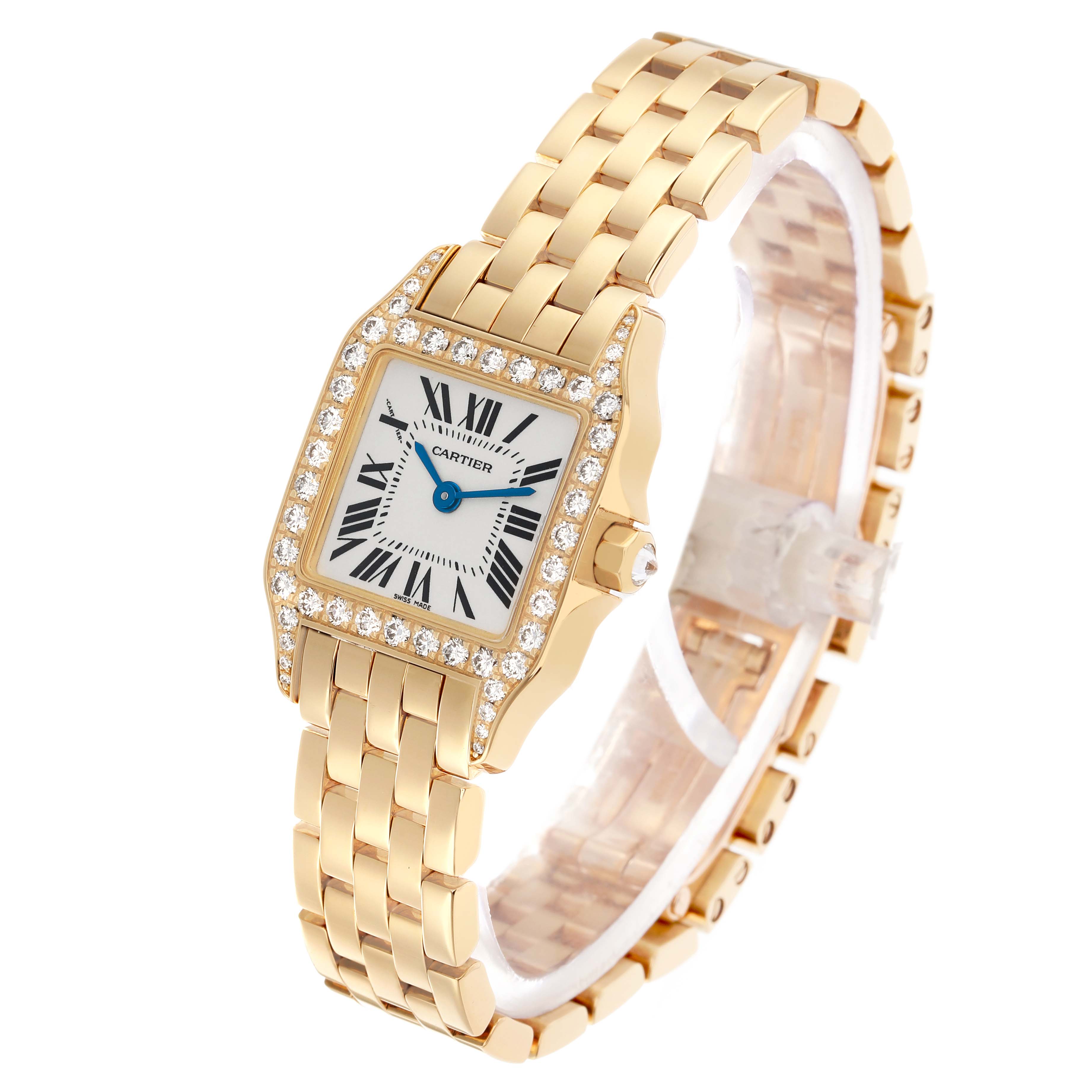 The Cartier Santos Demoiselle WF9001Y7 Women's Yellow Gold Silver Dial watch is angled to show the face, bezel, and part of the gold bracelet.