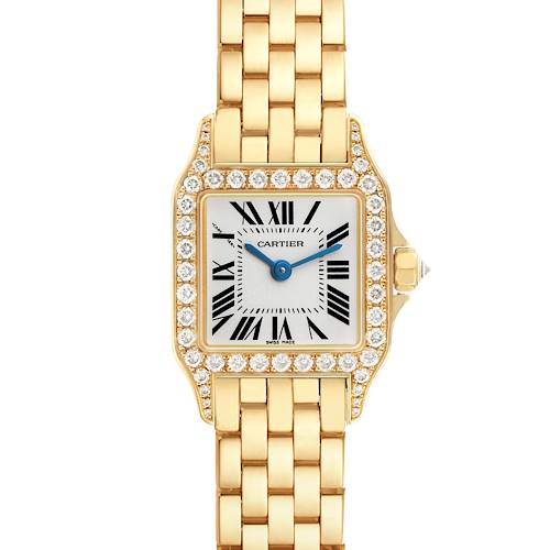 The Cartier Santos Demoiselle WF9001Y7 Women's Yellow Gold Silver Dial watch is shown from a top-down angle, highlighting its diamond-set bezel, dial, and gold bracelet.