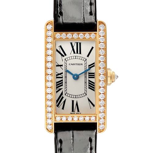 The Cartier Tank Americaine WB707231 Women's Yellow Gold Silver Dial watch is shown from a frontal angle, highlighting its diamond bezel, dial, and leather strap.