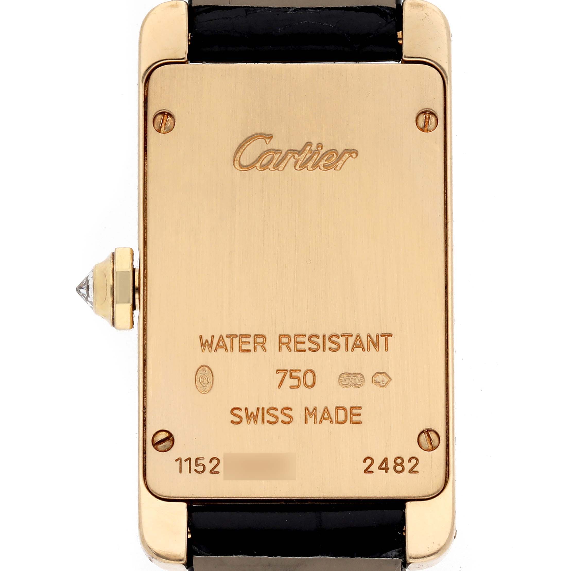 The image shows the back of the Cartier Tank Américaine watch, featuring engravings and the crown on the side.