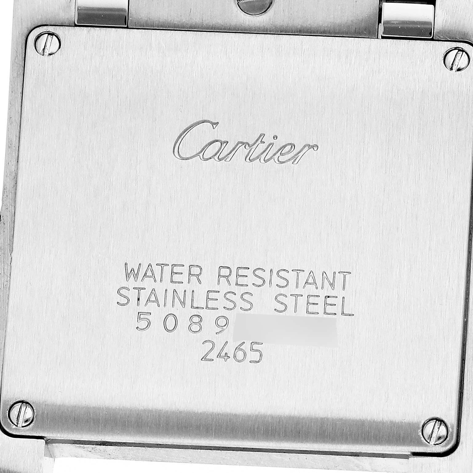 The image shows the case back of a Cartier Tank Française, highlighting the brand name and material details.
