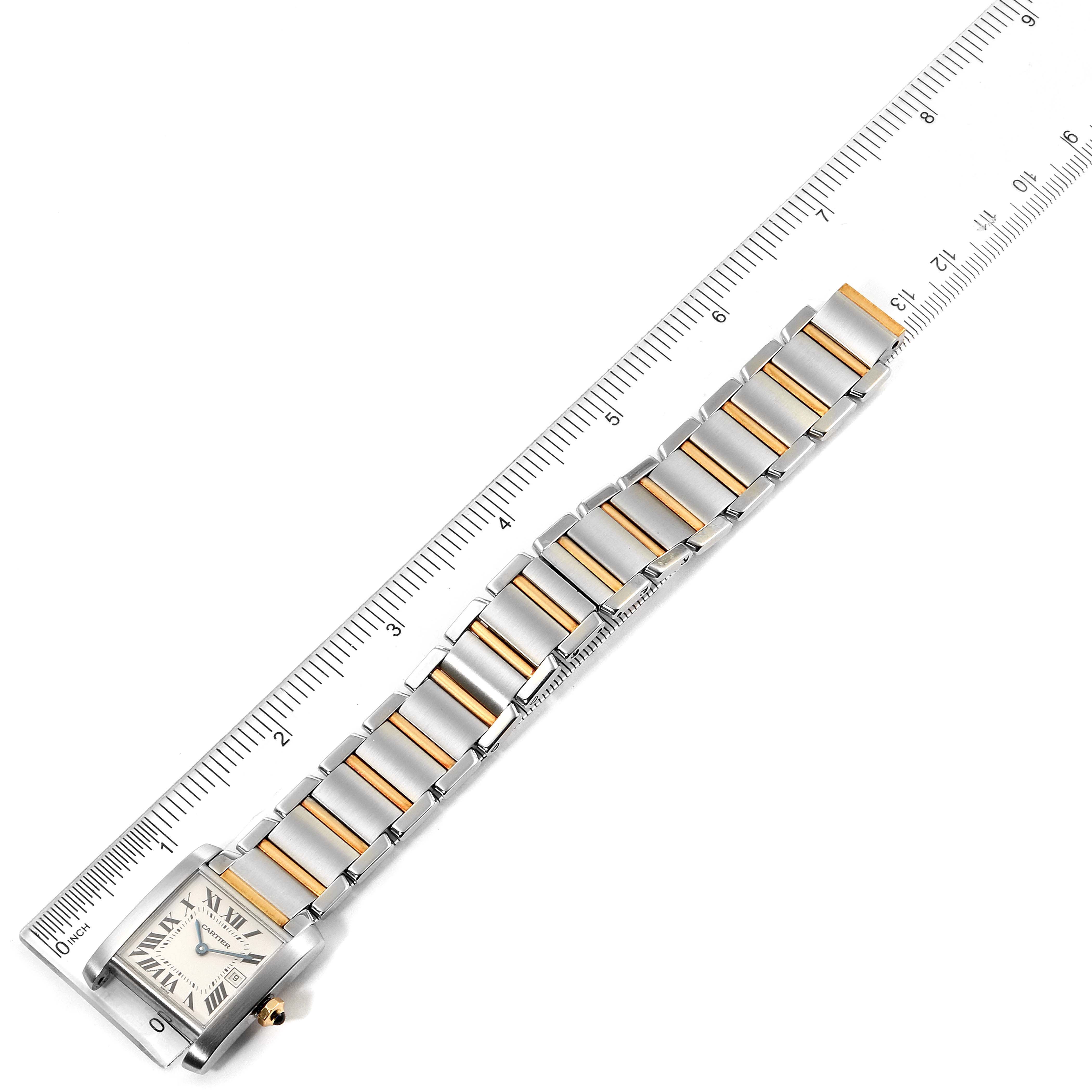 The image shows the Cartier Tank Française watch laid flat with a ruler beside it, displaying its face and bracelet.