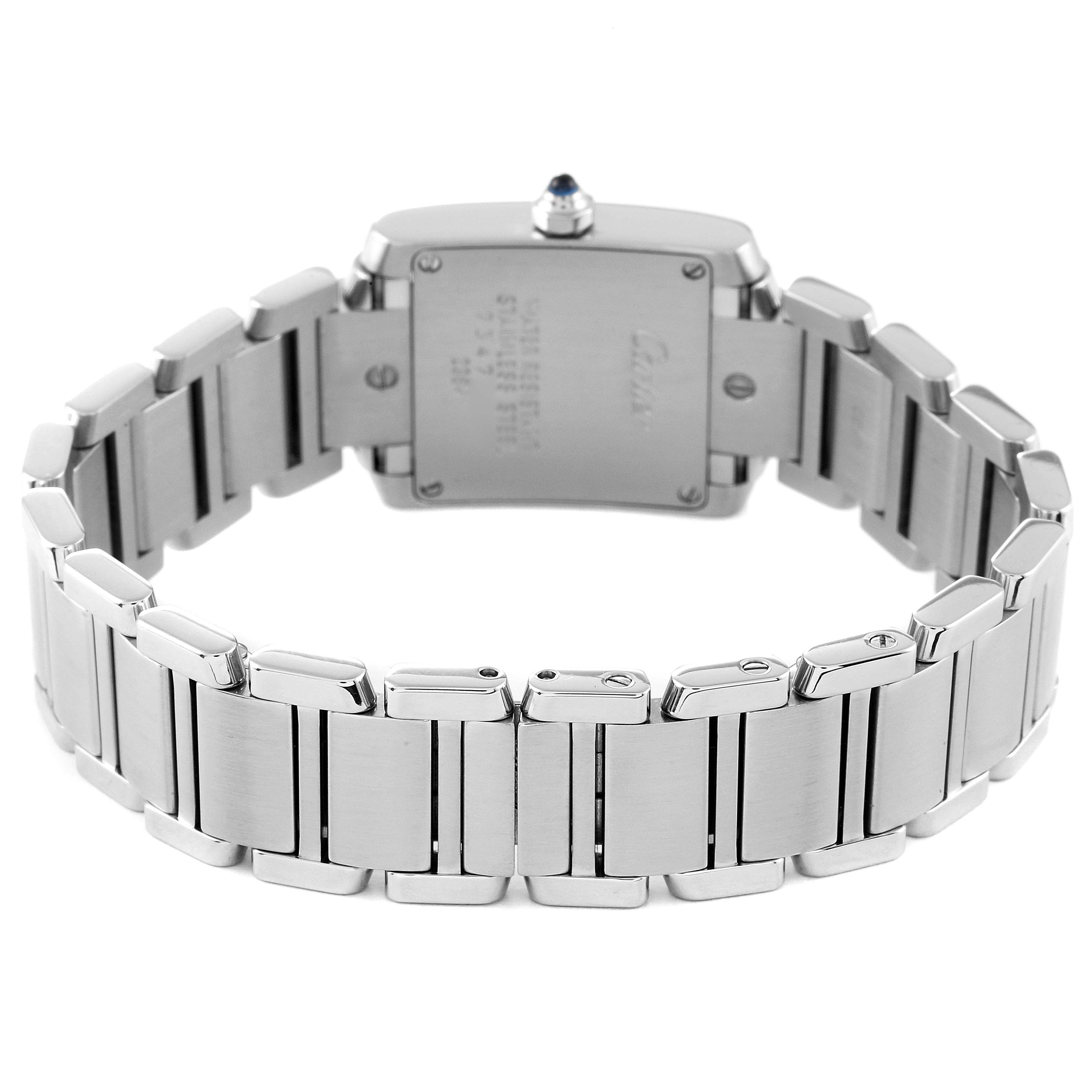 The image shows the back of a Cartier Tank Française watch with a focus on the stainless steel bracelet and case back.