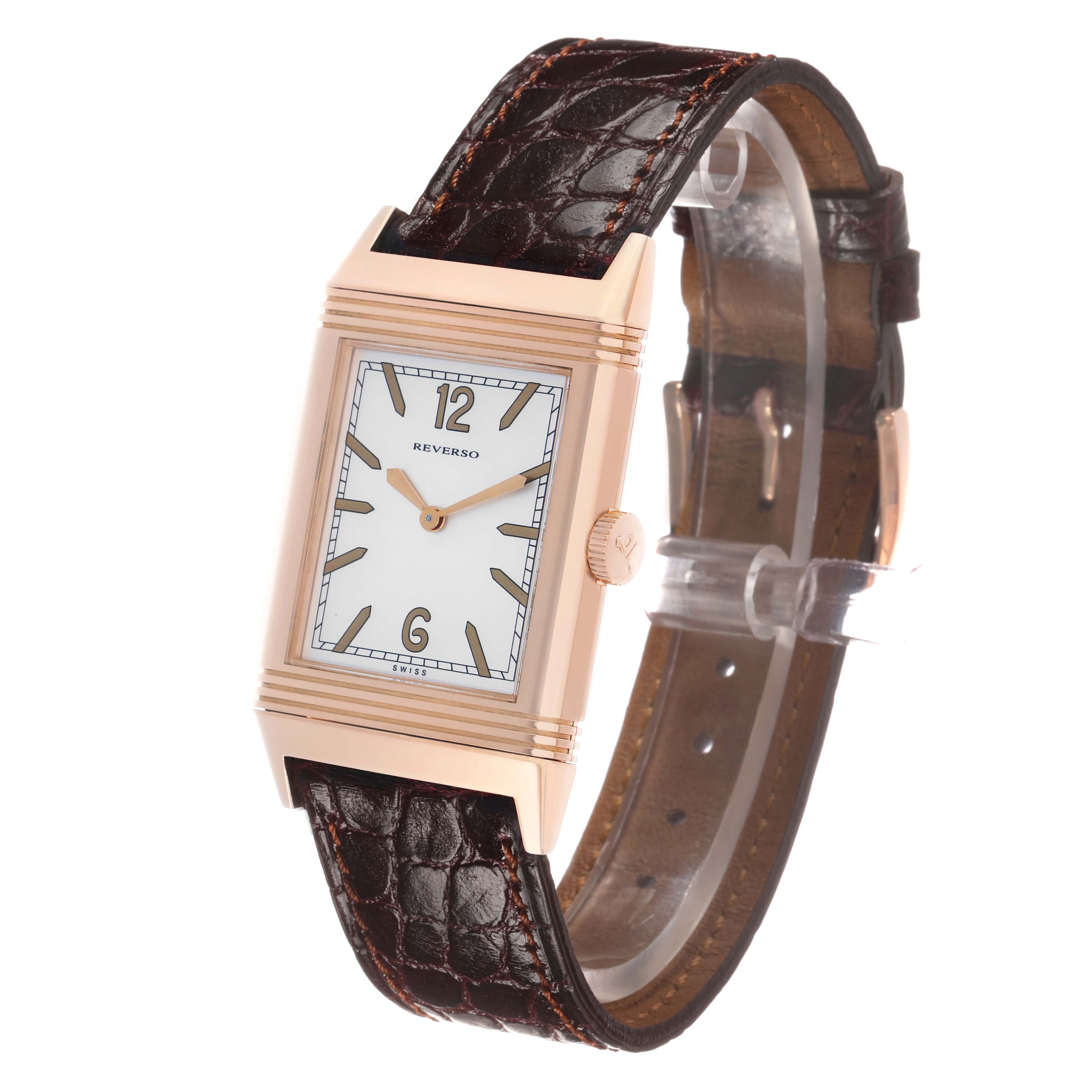 The Jaeger-LeCoultre Reverso watch is shown at a slight angle, displaying the face, crown, and leather strap.
