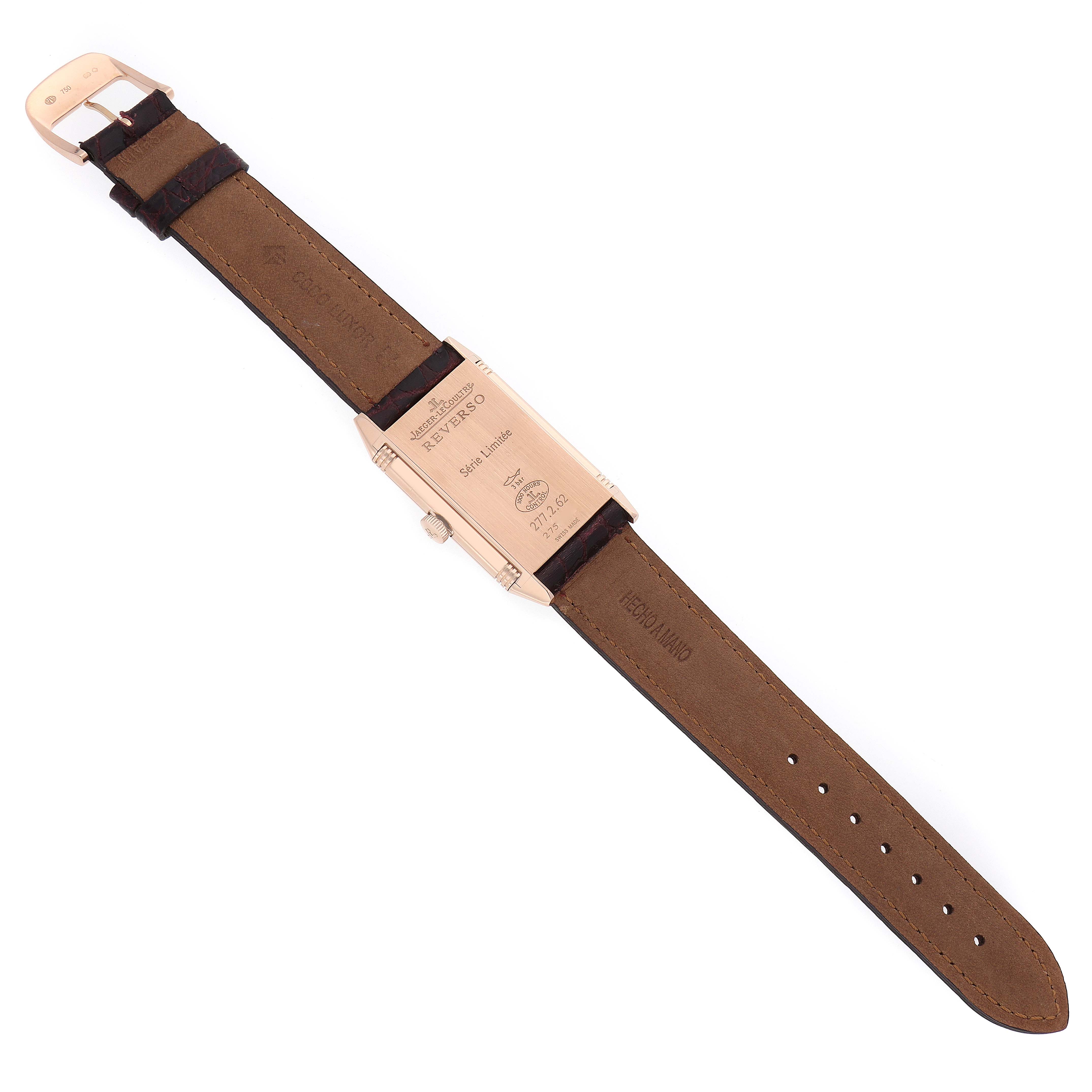 The Jaeger-LeCoultre Reverso watch is shown from the back, displaying the case back and leather strap.
