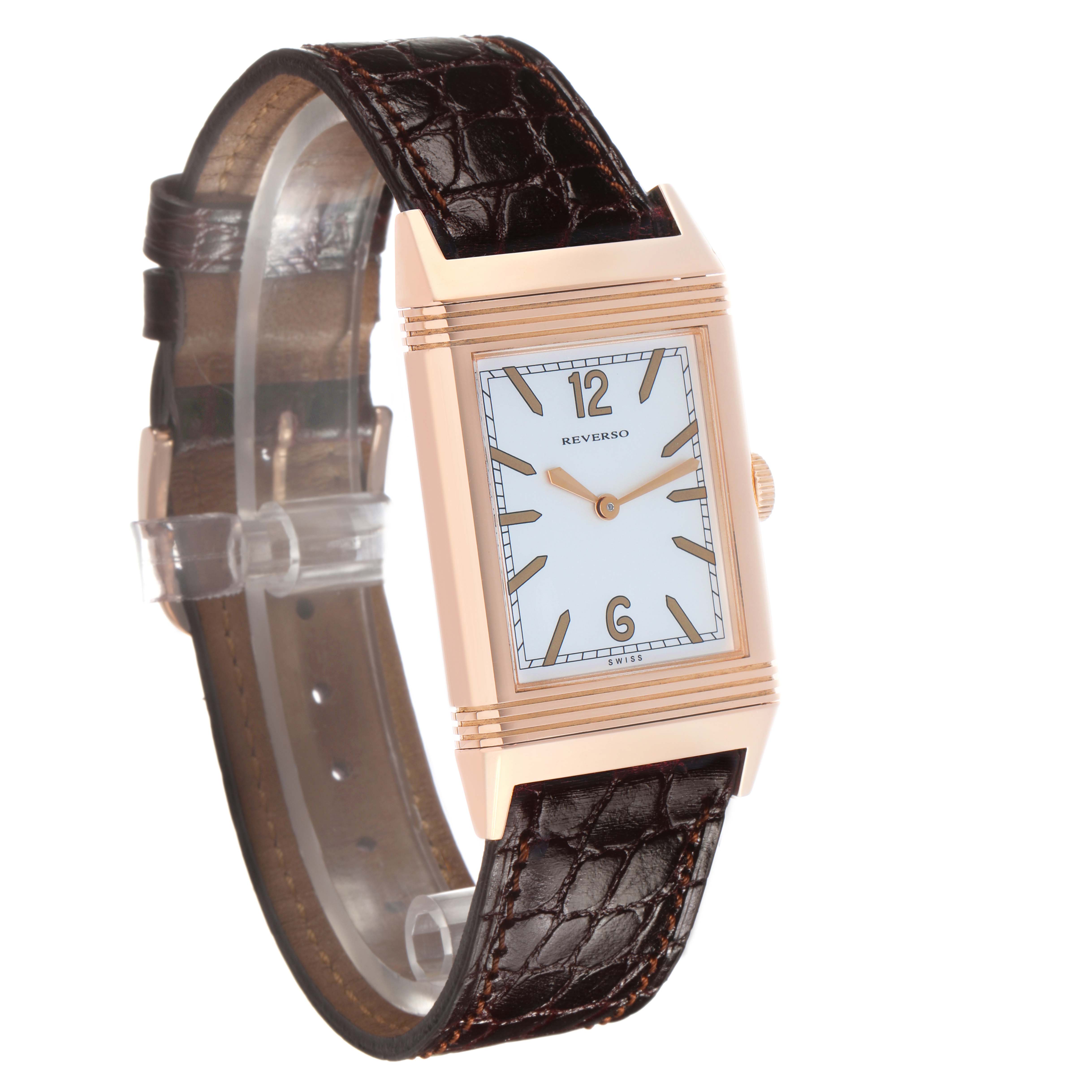The Jaeger-LeCoultre Reverso watch is shown at a three-quarter angle, highlighting the dial and leather strap.