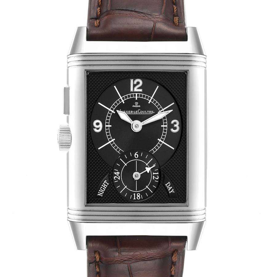 The Jaeger-LeCoultre Reverso watch is shown from the front, displaying the dial and date sub-dial, along with a brown leather strap.