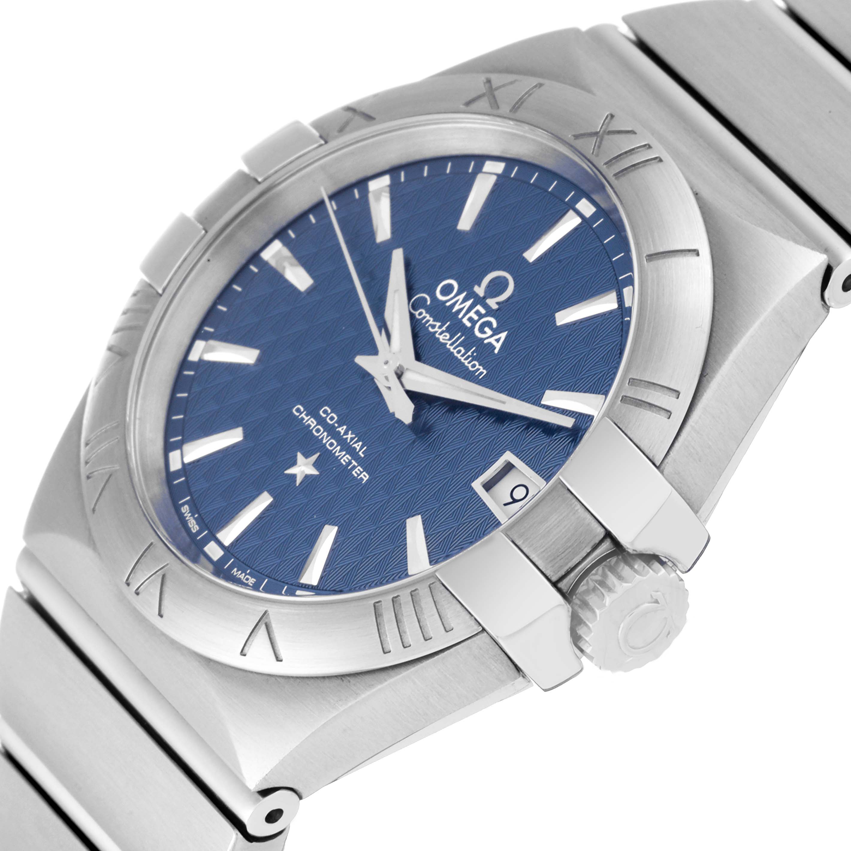 The image shows an angled view of the Omega Constellation 123.10.35.20.03.002 Men's Stainless Steel Blue Dial 123.10.35.20.03.002 Men's Stainless Steel Blue Dial watch, focusing on the dial, bezel, and crown.