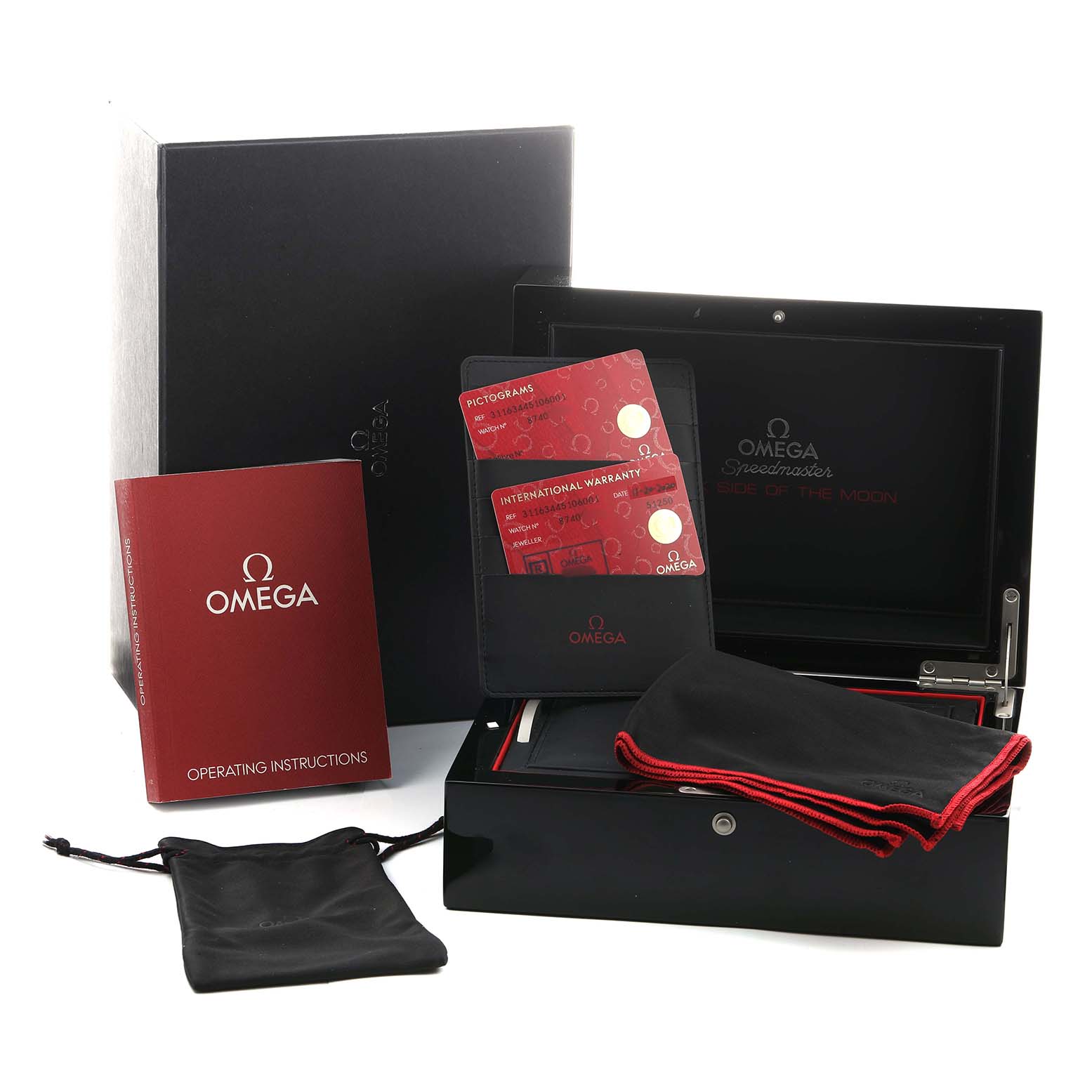 The image shows the Omega Speedmaster 311.63.44.51.06.001 Men's Ceramic Grey Dial's presentation box, warranty cards, instruction manual, and carrying pouches from a top angle.