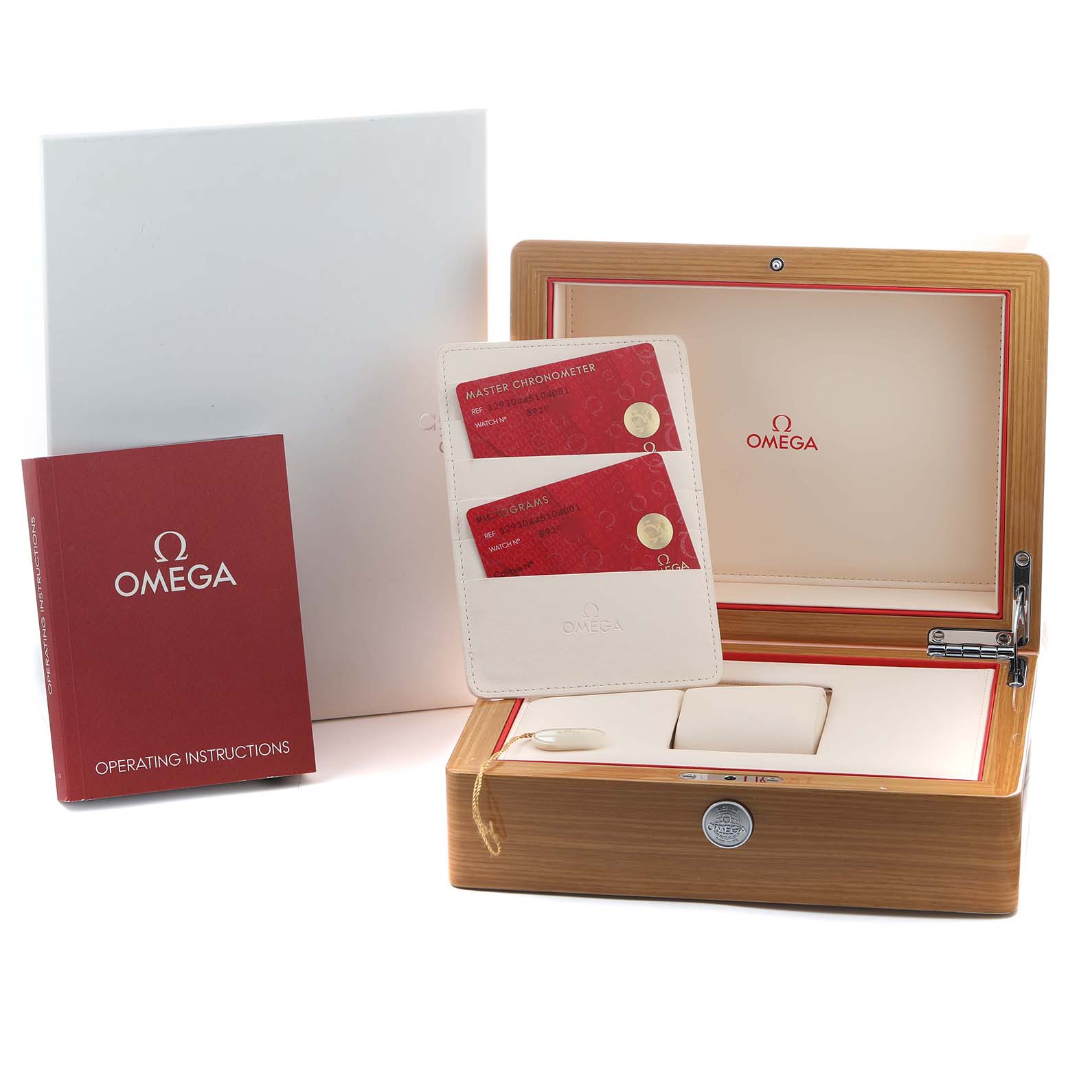 The image shows the Omega Speedmaster 329.30.44.51.04.001 Men's Stainless Steel Silver Dial's box, manual, warranty cards, and a case viewed from above.