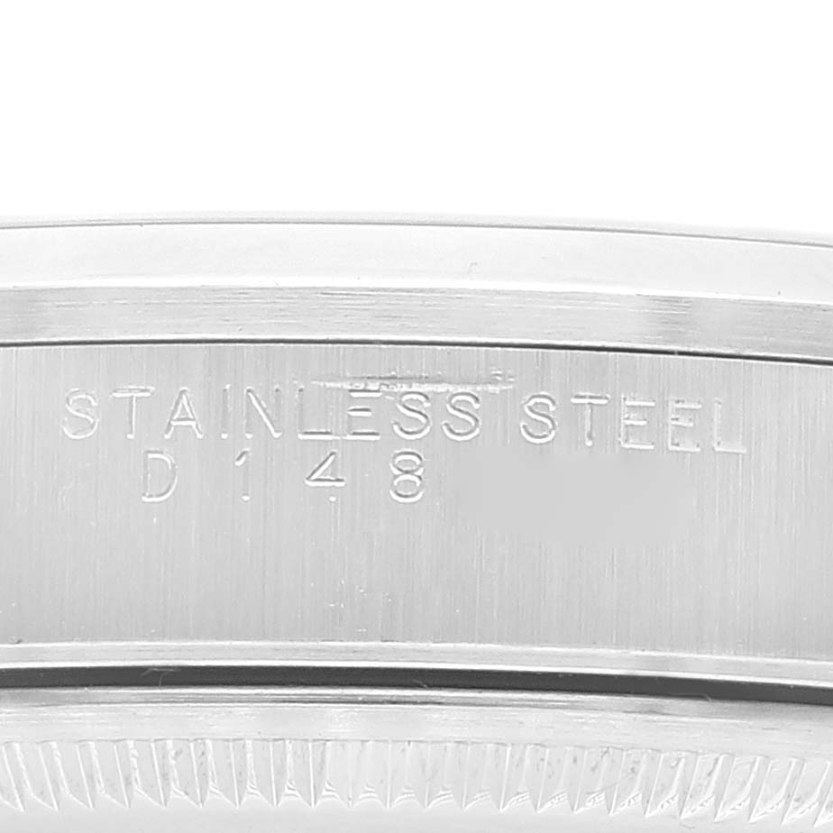 The image shows a close-up of the side of a Rolex Air-King 14000 Men's Stainless Steel Silver Dial 14000 Men's Stainless Steel Silver Dial watch, highlighting the engraving "STAINLESS STEEL" and the serial number.