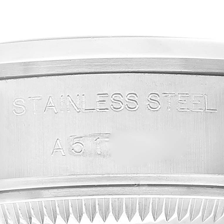 The image shows a close-up of the side of a Rolex Date 79160 Women
s Stainless Steel White Dial 79160 Women
s Stainless Steel White Dial model watch, highlighting the stainless steel engraving.