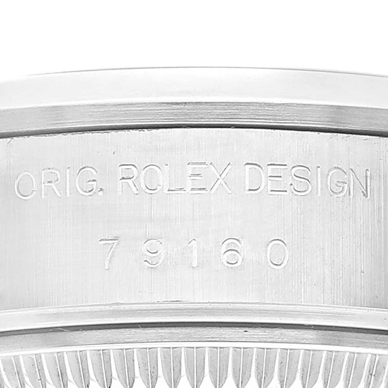The image shows a close-up side view of the casing of a Rolex Date 79160 Women
s Stainless Steel White Dial 79160 Women
s Stainless Steel White Dial model watch, featuring the engraved design and model number.
