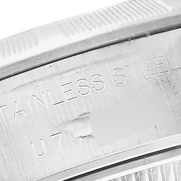 The image shows a close-up of the caseback for a Rolex Date 69190 Women's Stainless Steel Silver Dial 69190 Women's Stainless Steel Silver Dial watch, highlighting the stainless steel material engraving.