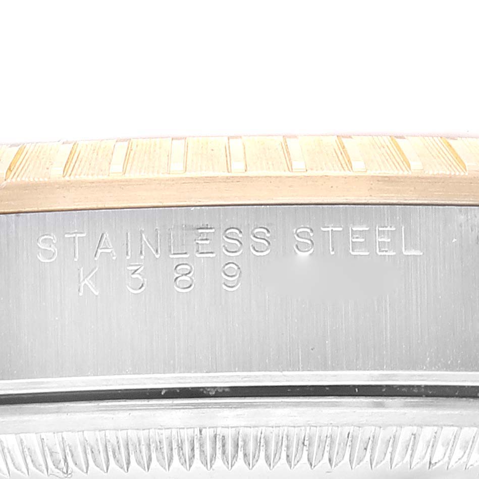 The image shows an engraved "STAINLESS STEEL" and serial number on the case side of a Rolex Datejust 15223 Men's Steel and Gold (two tone) Champagne Dial 15223 Men's Steel and Gold (two tone) Champagne Dial watch.