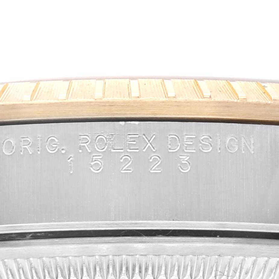 This image shows a close-up of the bezel and engraved serial number on a Rolex Datejust 15223 Men's Steel and Gold (two tone) Champagne Dial 15223 Men's Steel and Gold (two tone) Champagne Dial watch.