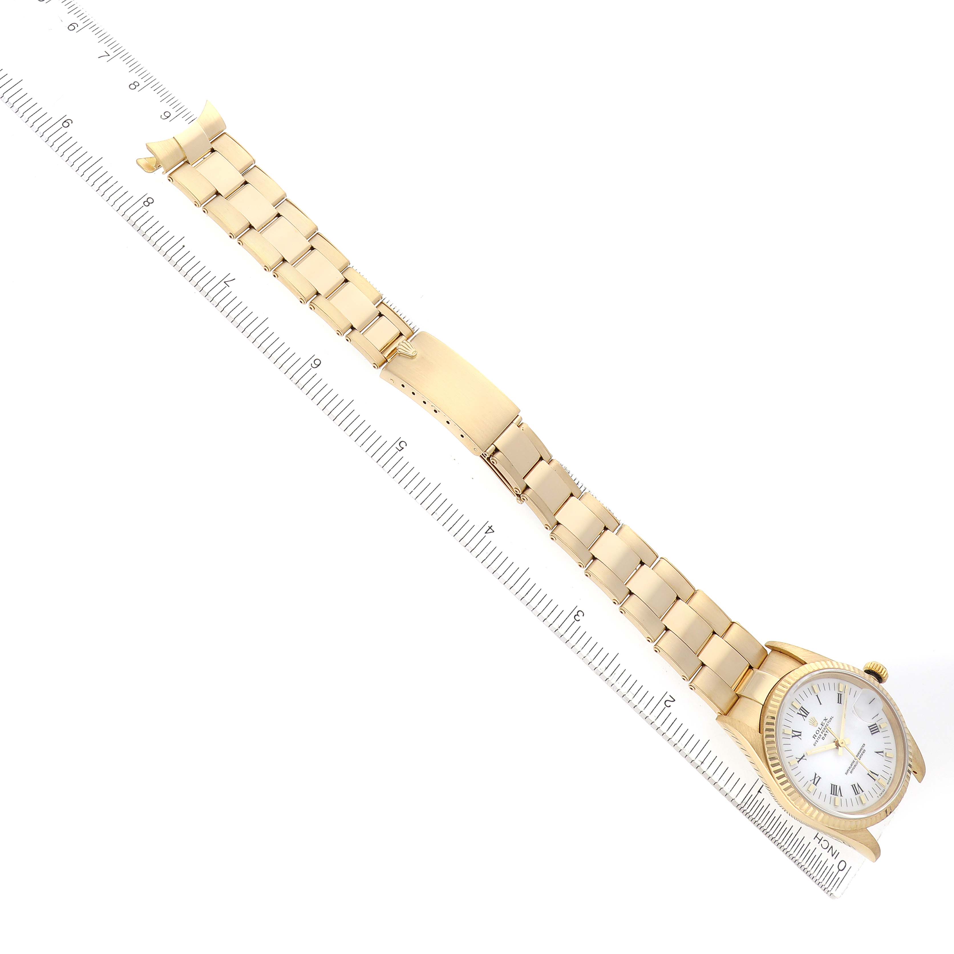 The Rolex Date 15238 Men's Yellow Gold White Dial watch is shown diagonally with its full bracelet and clasp visible alongside a ruler for scale.