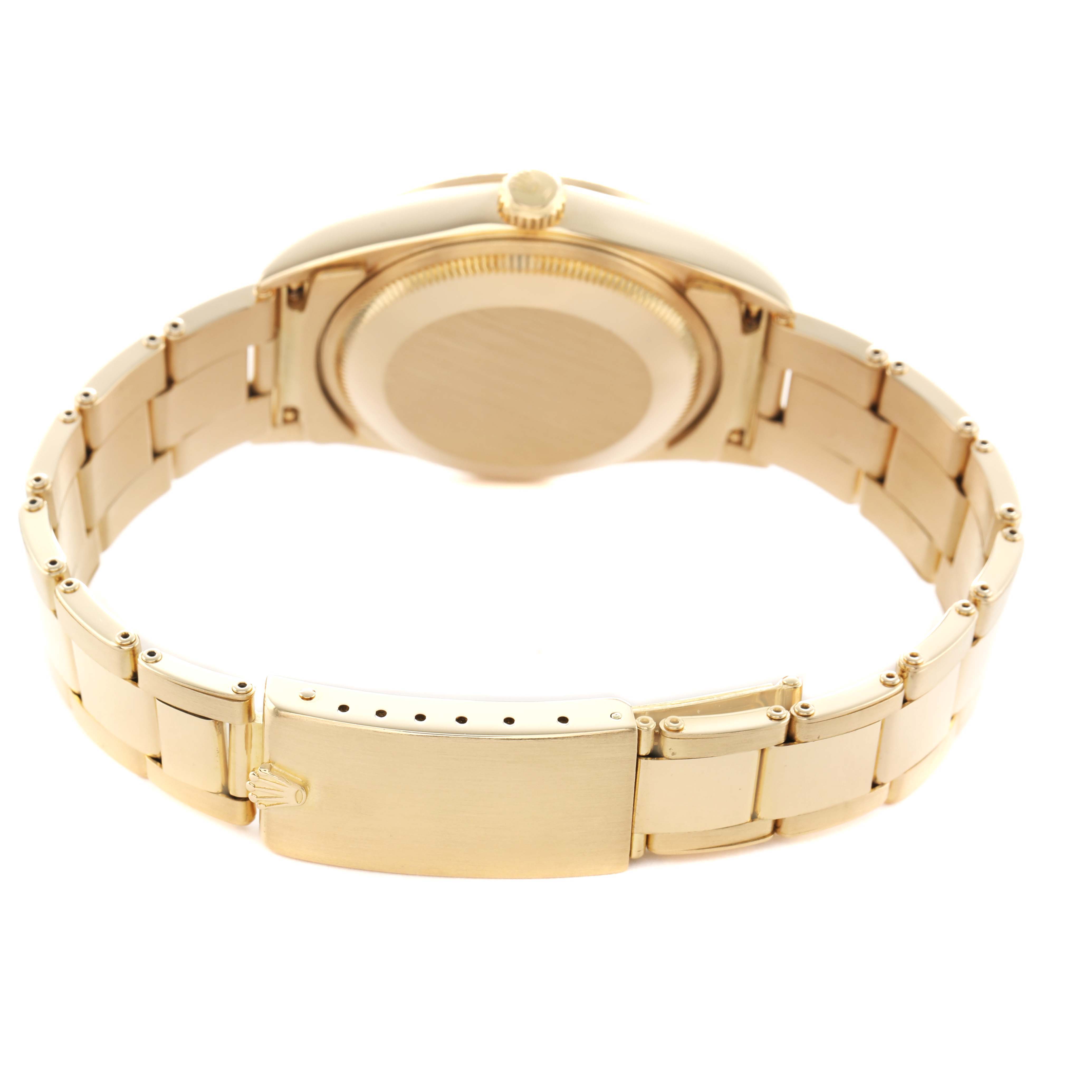 The image shows the back of a Rolex Date 15238 Men's Yellow Gold White Dial watch, focusing on the clasp, case back, and bracelet from a rear angle.