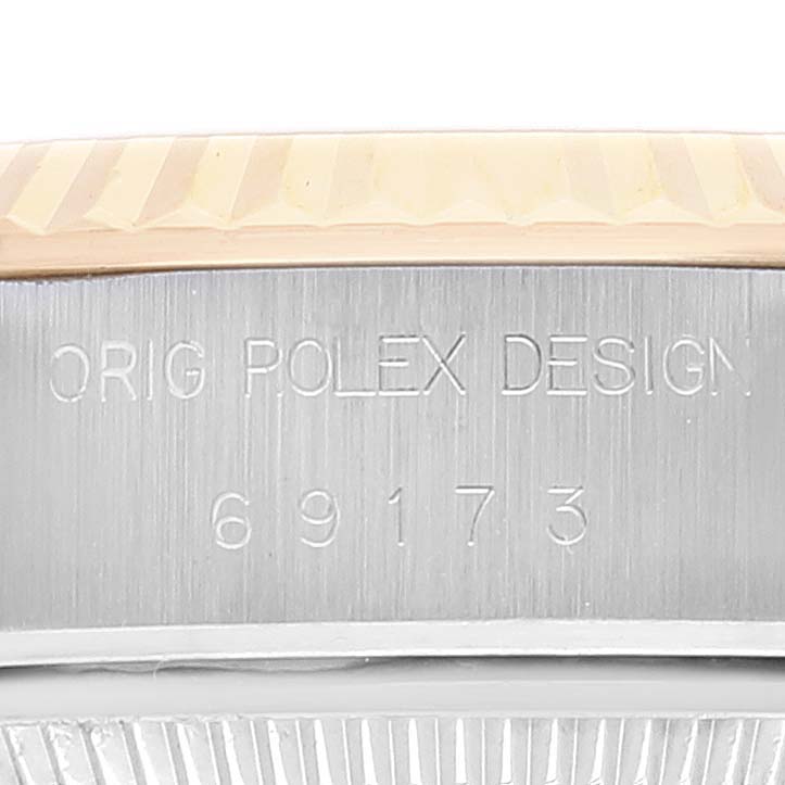 This is a close-up shot of the side of a Rolex Datejust 69173 Women's Steel and Gold (two tone) Champagne Dial 69173 Women's Steel and Gold (two tone) Champagne Dial, showing the model number 69173 and "ORIG ROLEX DESIGN" engraving.