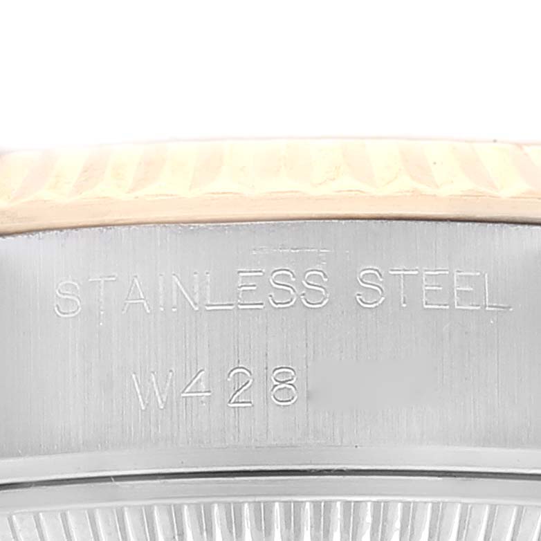 This close-up image shows the side of a Rolex Datejust 69173 Women's Steel and Gold (two tone) Champagne Dial 69173 Women's Steel and Gold (two tone) Champagne Dial, focusing on the stainless steel material and engraved serial number.