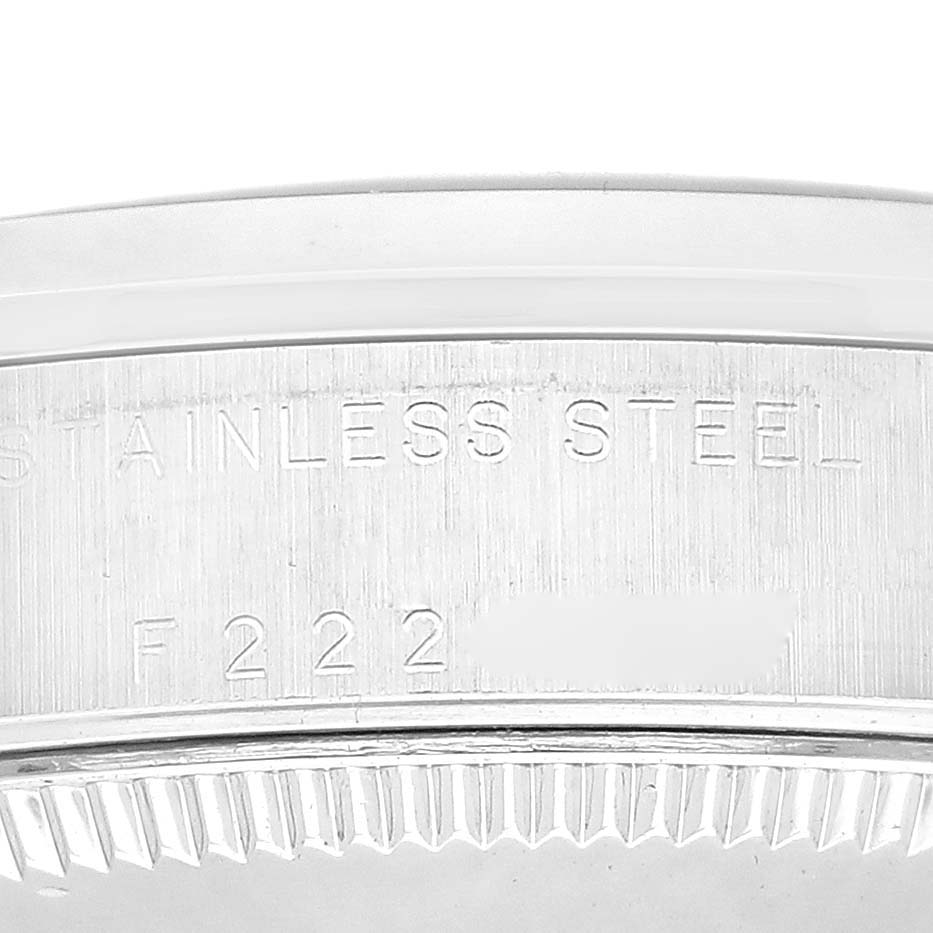 The image shows a close-up of the stainless steel case side of a Mid-Size Rolex watch, highlighting the engraved serial number.