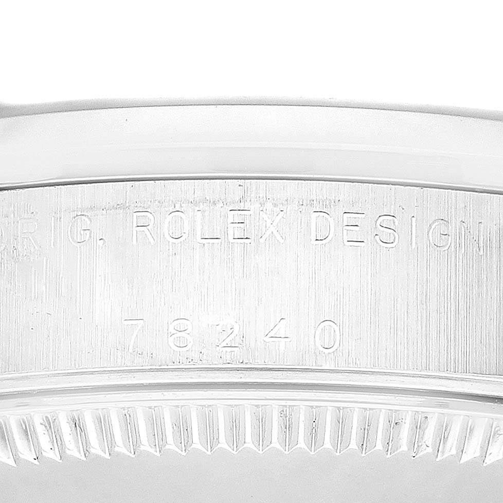 This close-up image captures the engraved serial number and model information on the side of a mid-size Rolex watch.