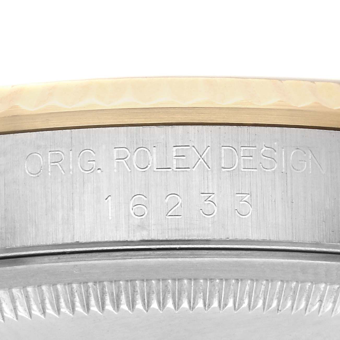 The image shows the engraved reference number and part of the bezel on a Rolex Datejust 16233 Men's Steel and Gold (two tone) Black Dial 16233 Men's Steel and Gold (two tone) Black Dial watch at a close-up angle.