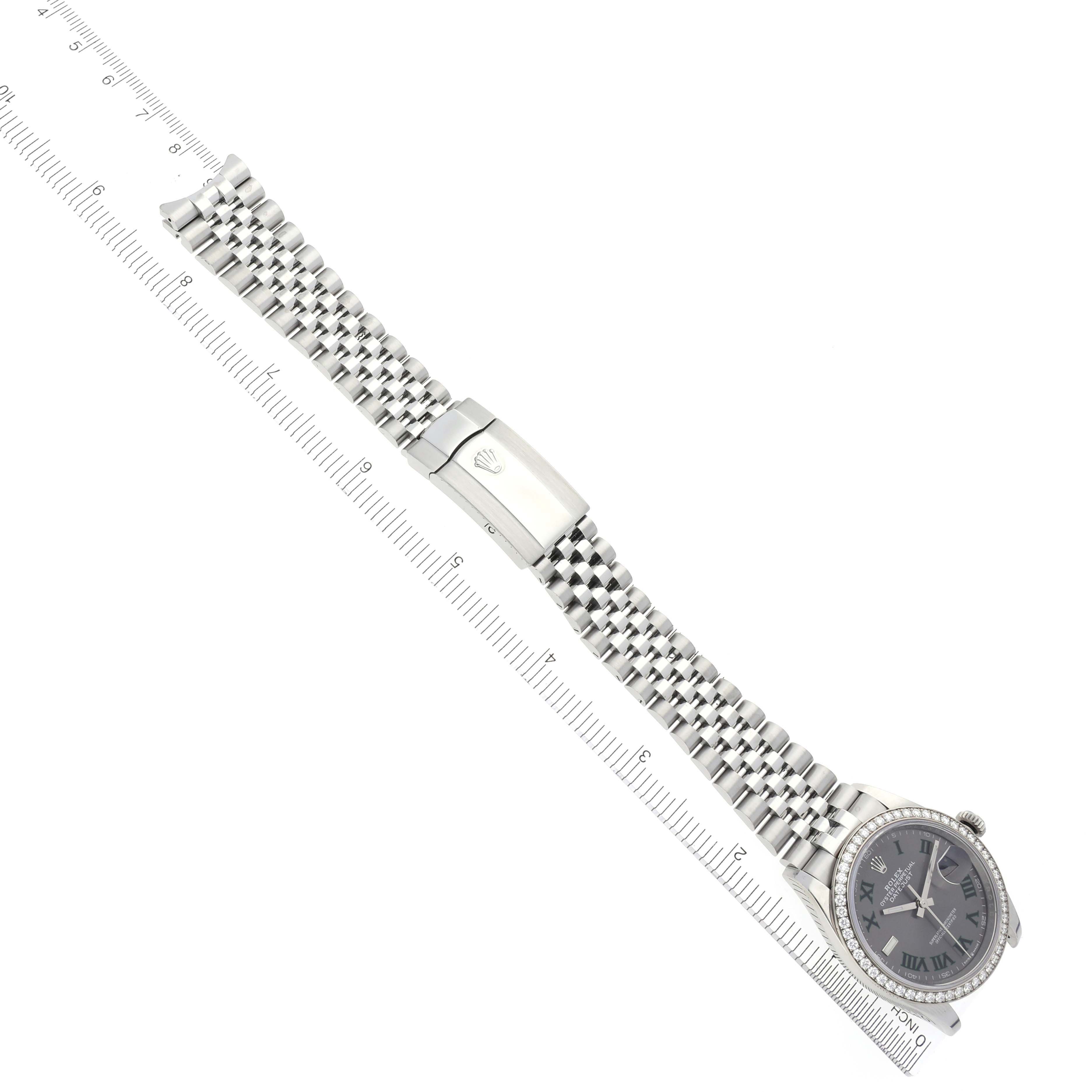 The Rolex Datejust 126284RBR Men's Stainless Steel Grey Dial 126284RBR Men's Stainless Steel Grey Dial watch is shown from the top view, highlighting its bracelet and clasp with a ruler for scale.