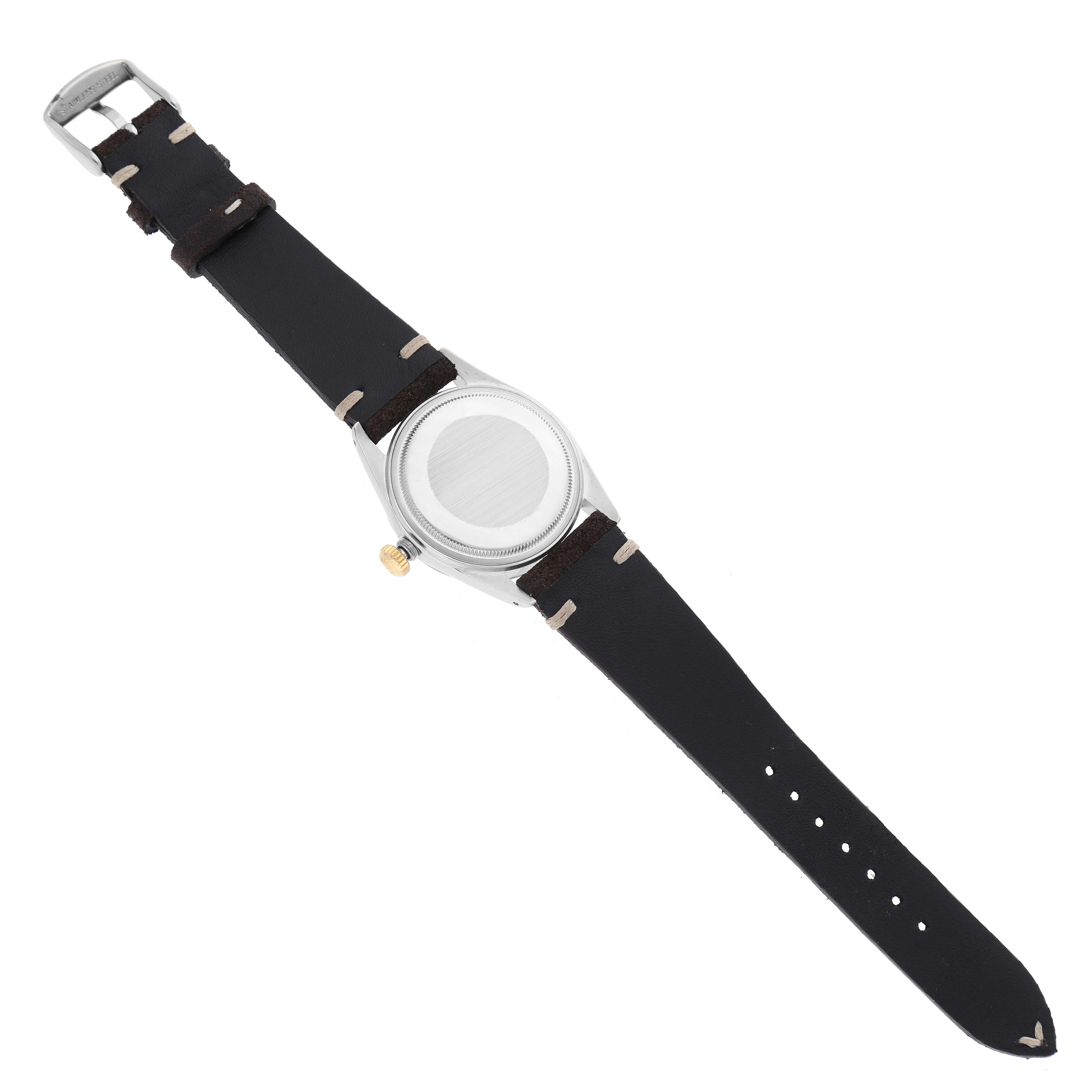 This Rolex Datejust 16013 Men's Steel and Gold (two tone) Champagne Dial 16013 Men's Steel and Gold (two tone) Champagne Dial watch is shown from the back, displaying its black leather strap and metallic case.