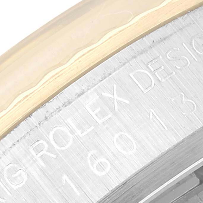 The image shows a close-up of the bezel and part of the case with engraved text of a Rolex Datejust 16013 Men's Steel and Gold (two tone) Champagne Dial 16013 Men's Steel and Gold (two tone) Champagne Dial model.