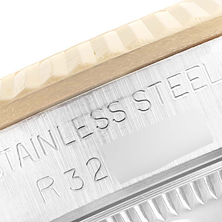 This close-up image shows the side of the bezel and the engraved stainless steel case back of the Rolex Mid-Size 68273 Women's Steel and Gold (two tone) Champagne Dial 68273 Women's Steel and Gold (two tone) Champagne Dial model watch.