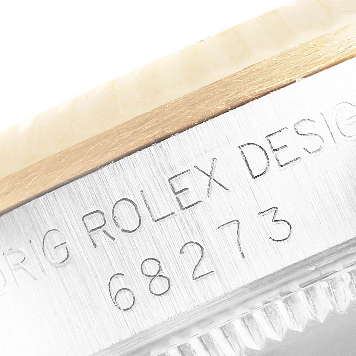 This is a close-up of the casing of a Rolex Mid-Size 68273 Women's Steel and Gold (two tone) Champagne Dial 68273 Women's Steel and Gold (two tone) Champagne Dial model, showing the "ROLEX DESIGN" engraving and model number 68273.